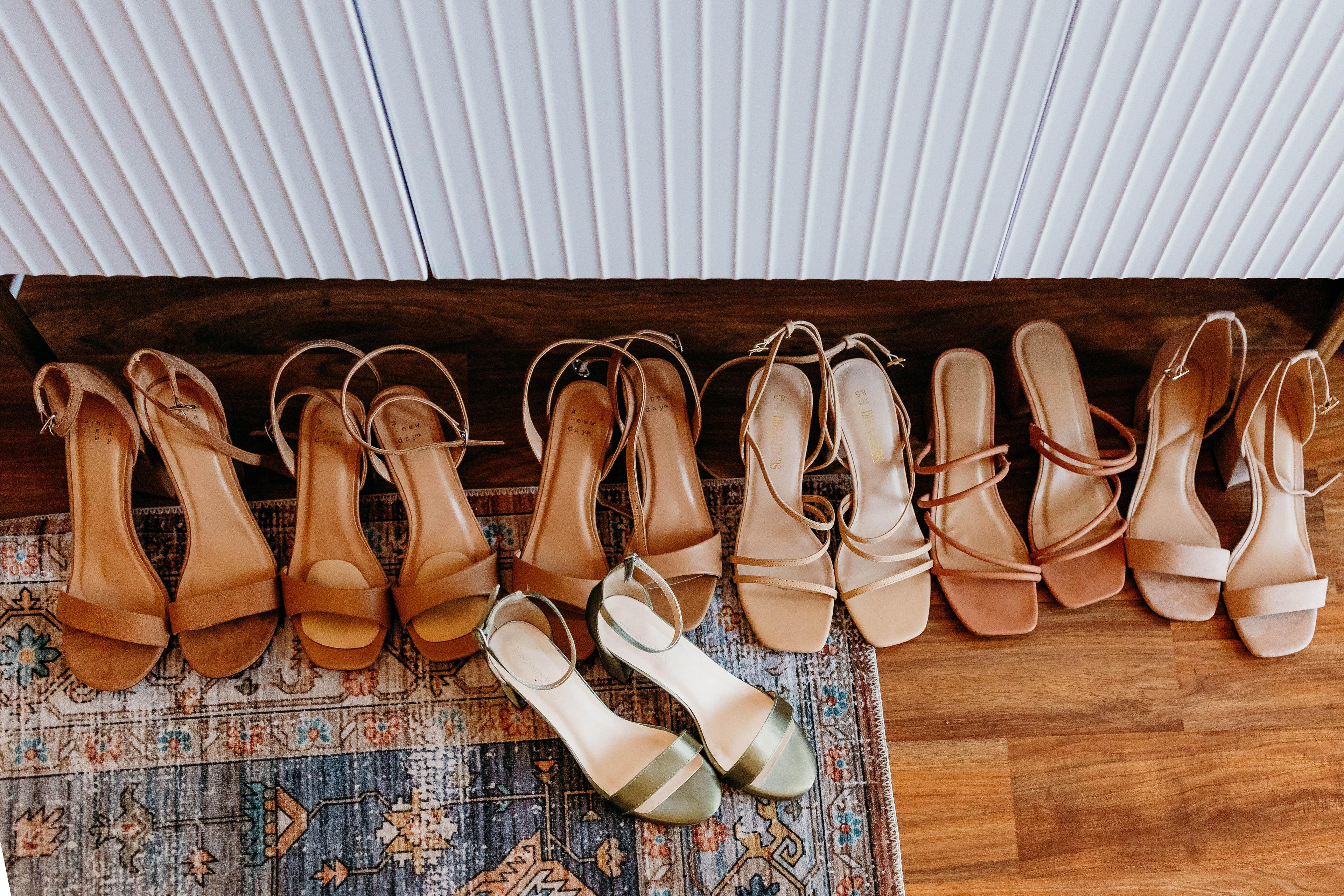 A row of bridesmaids’ shoes waiting by the window — soft tones, timeless details, and that quiet excitement before a White Mountains wedding begins.