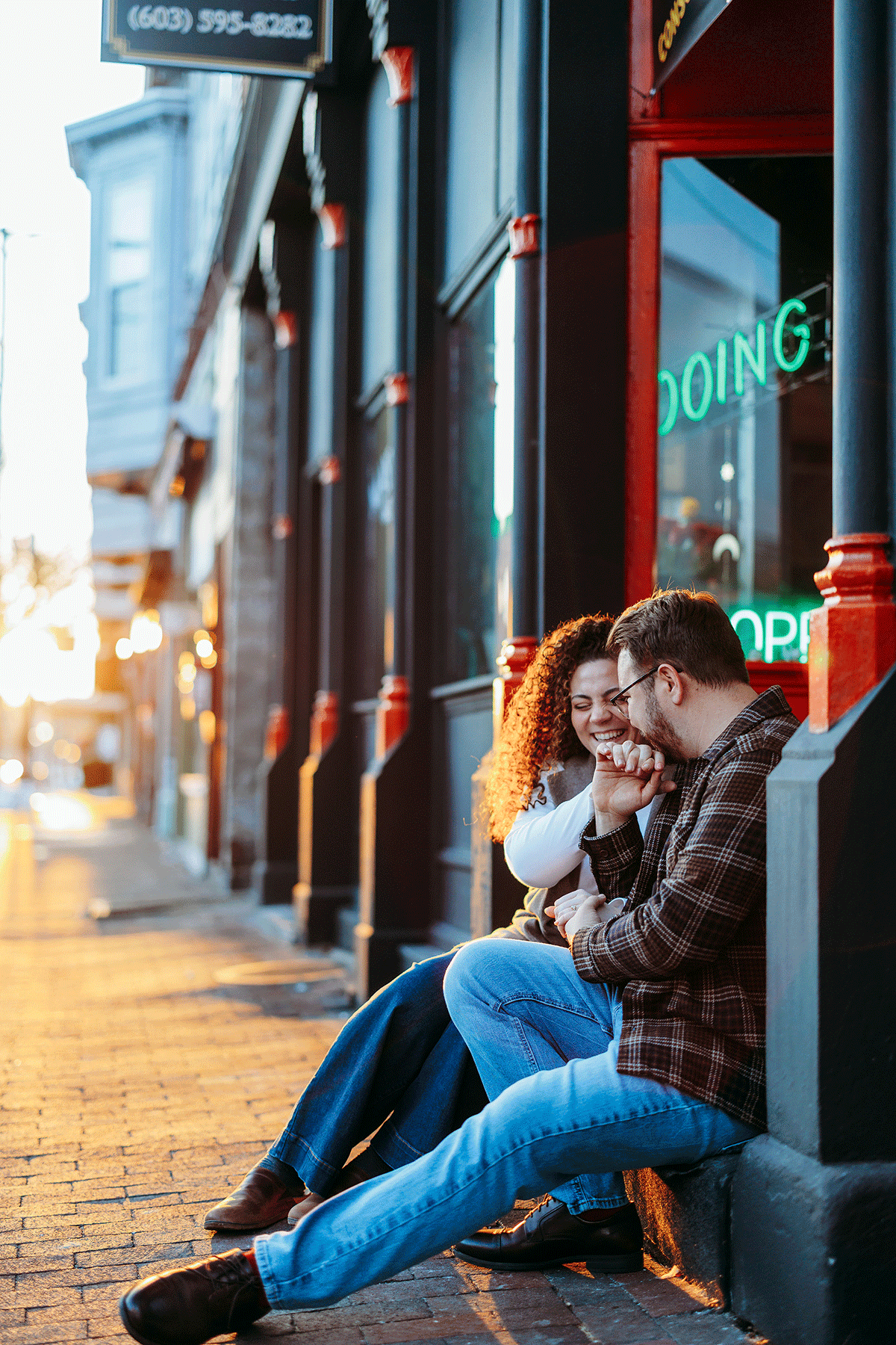 Candid engagement photos in a local Nashua bookstore, focused on connection, not performance.