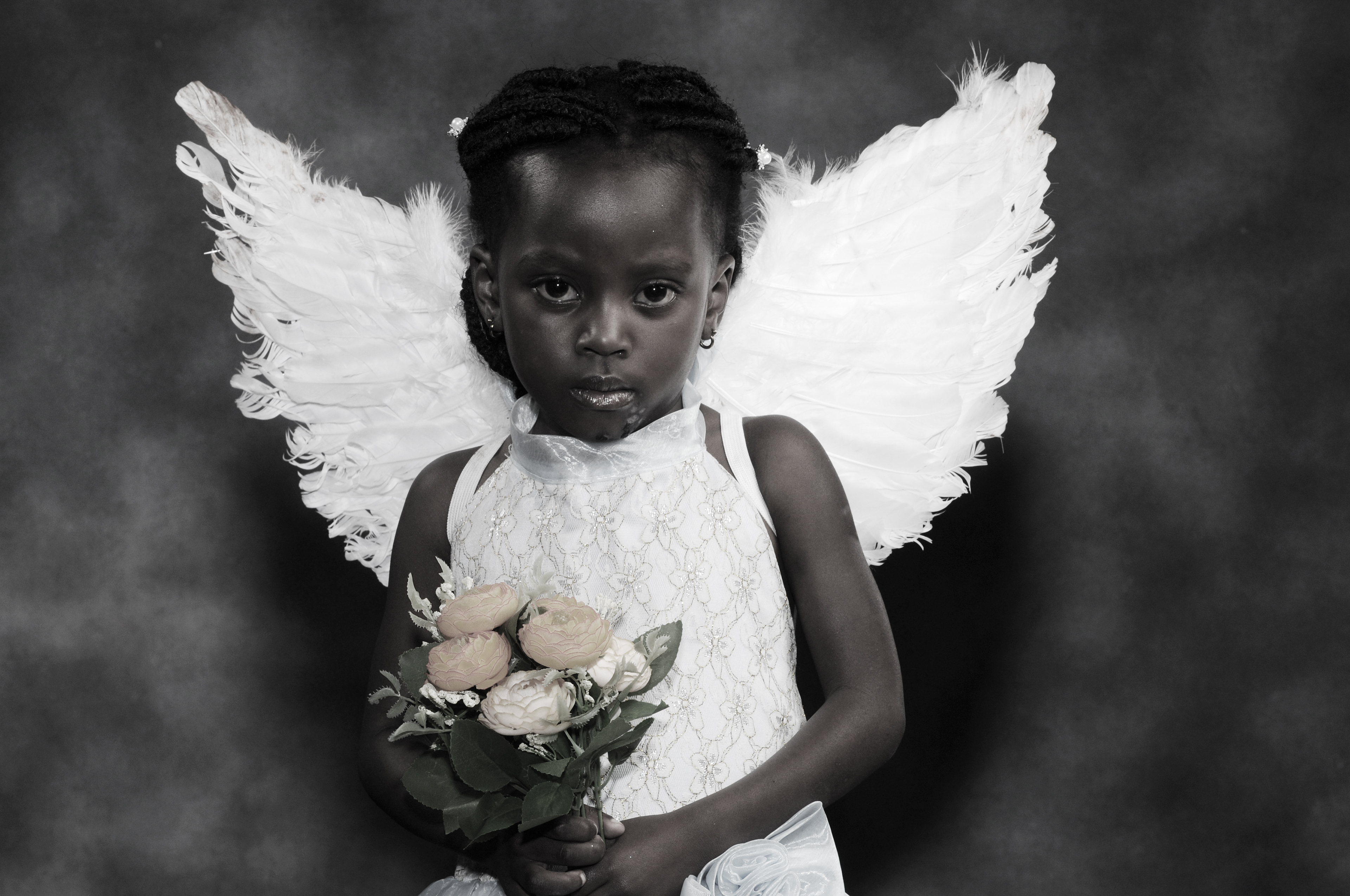 Portrait poses little angle girl with roses