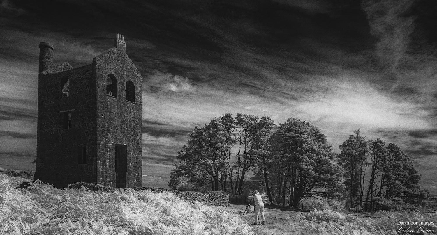 A photographer making an image of the old engine house at Minions on a summers afternoon in Cornwall.