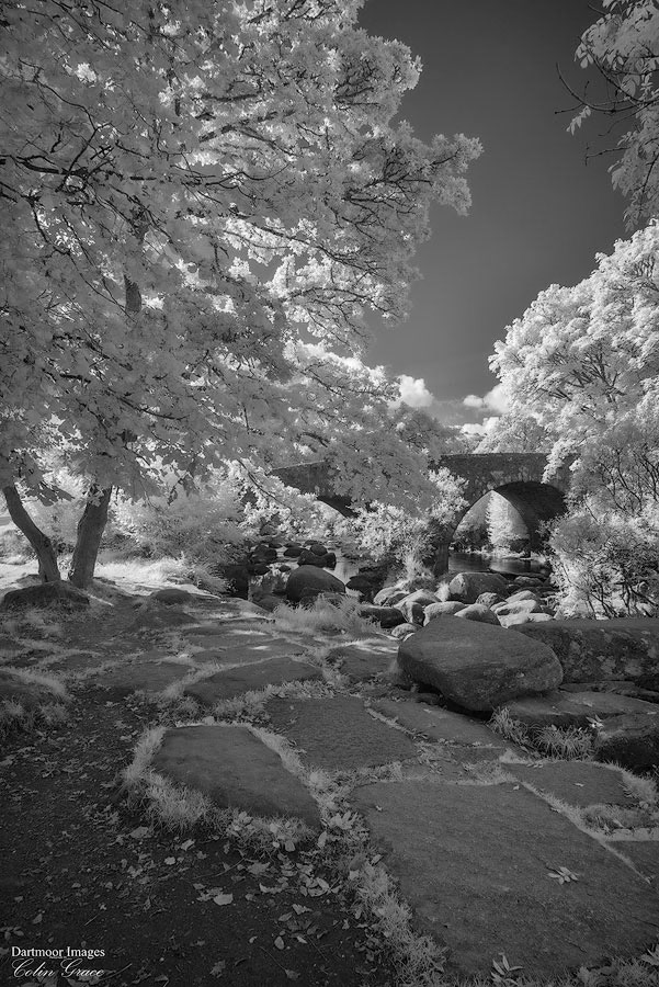 The old clapper bridge and more modern road bridge over the River Dart at Dartmeet on Dartmoor.