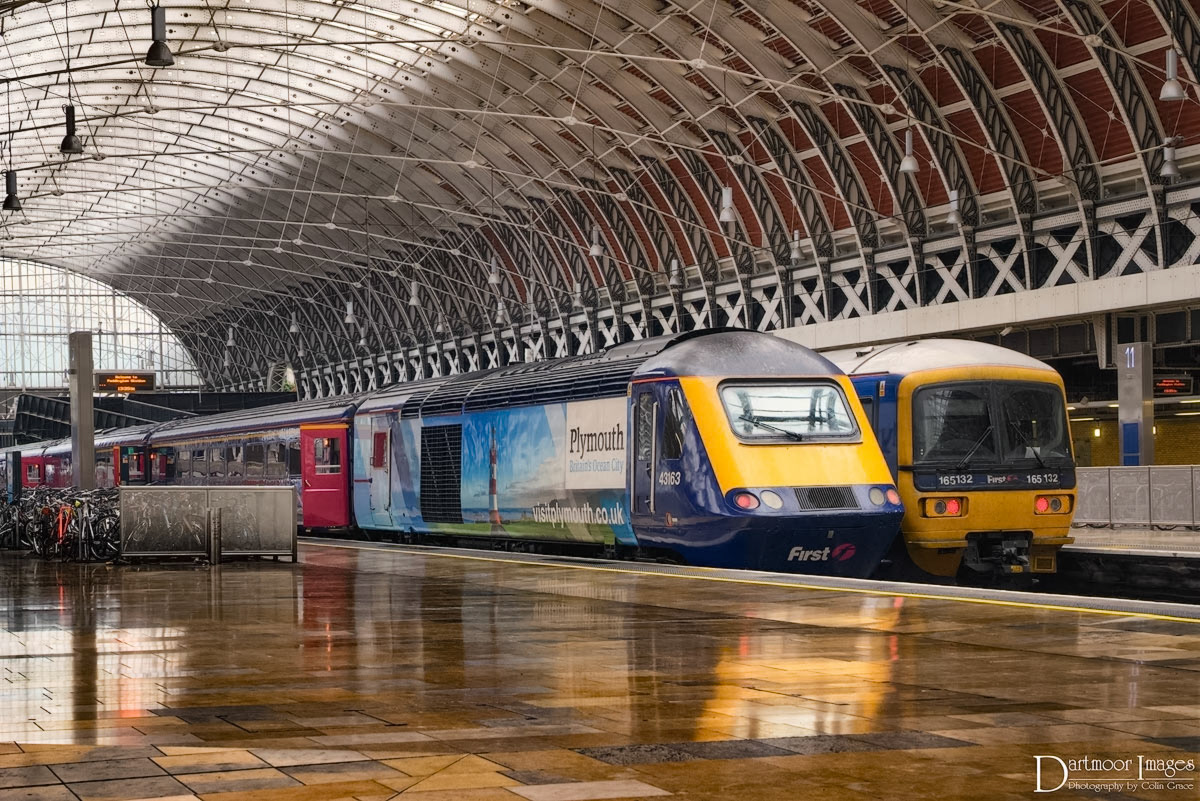 A high speed train sits at Platform 9 at Paddington Station, reflected in the highly poslished floor, waiting for passengers to board for Plymouth and stations in between.