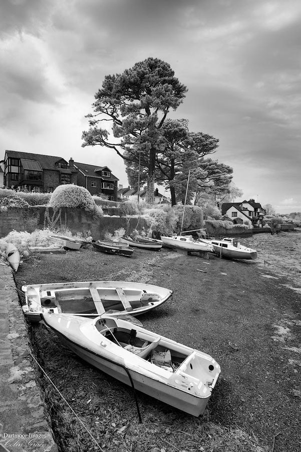 Low tide on the River Tamar leaves small boats high and dry on the shoreline at Saltash.
