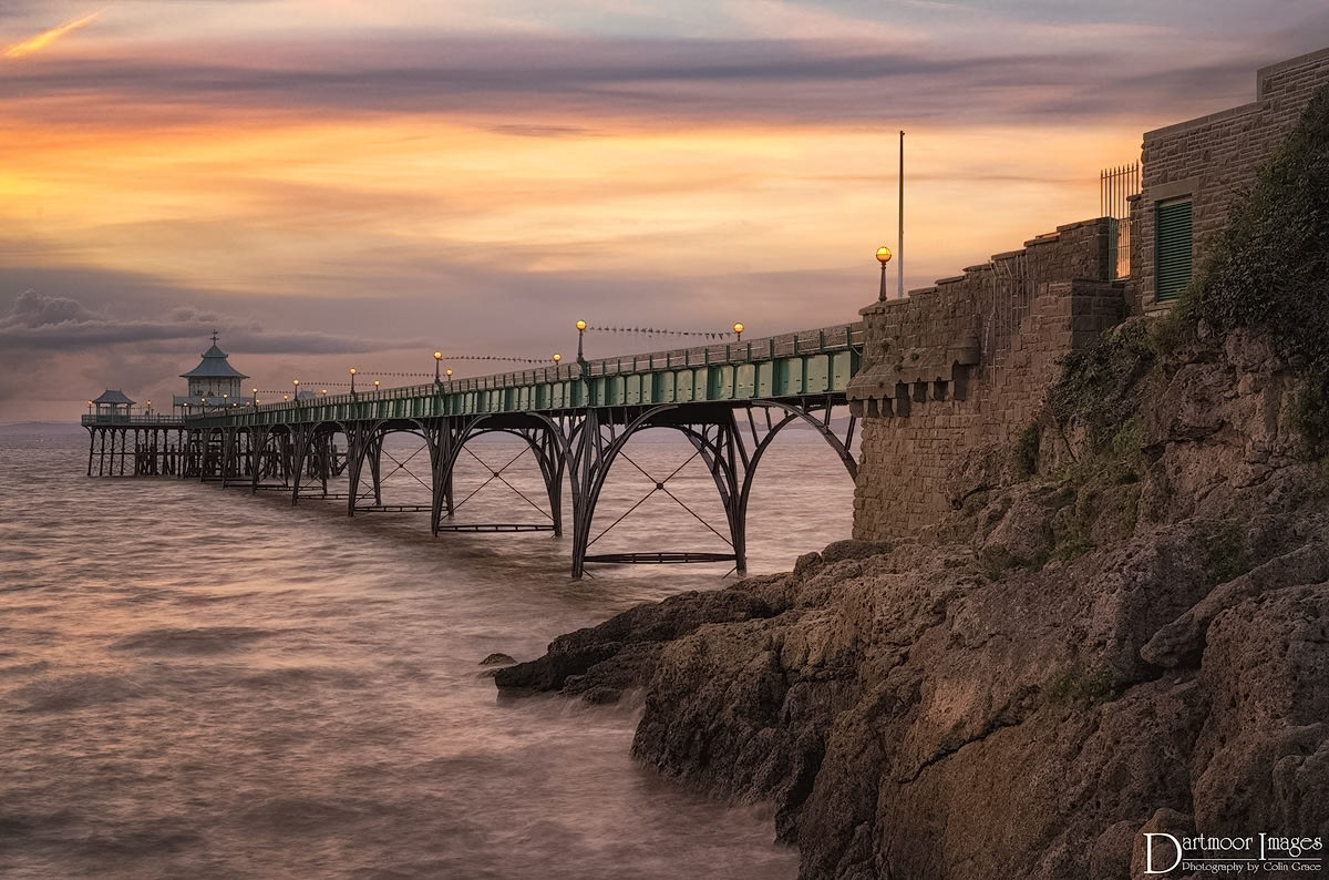 The old victorian pier at Clevedon in Somereset during a colourful sunset over the Bristol Channel.