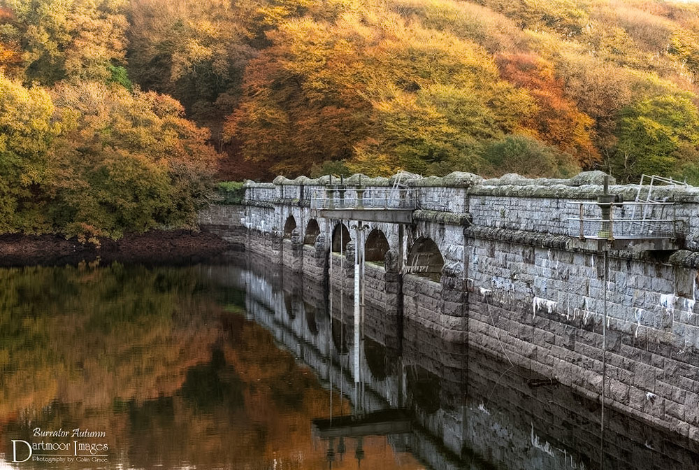 Autumn colours surround the dam at Burrator Reservoir on Dartmoor.
