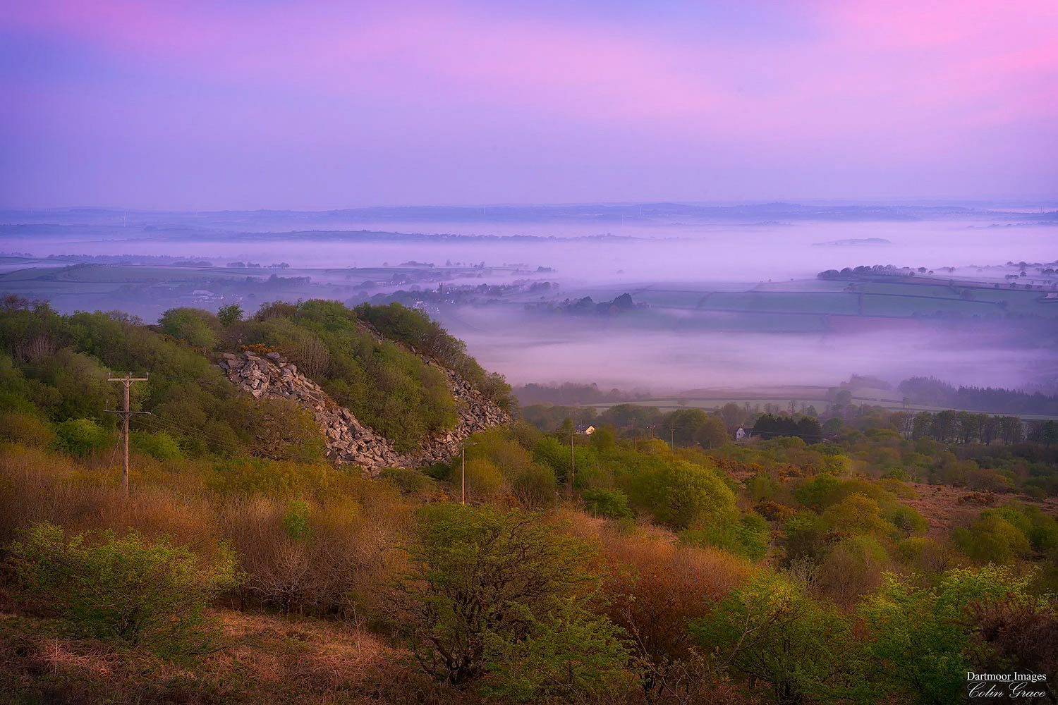 The Cornish countryside is bathed in early morning spring  light as mist and fog hangs in the valleys and lowlands of the landscape beyond Kit Hill.