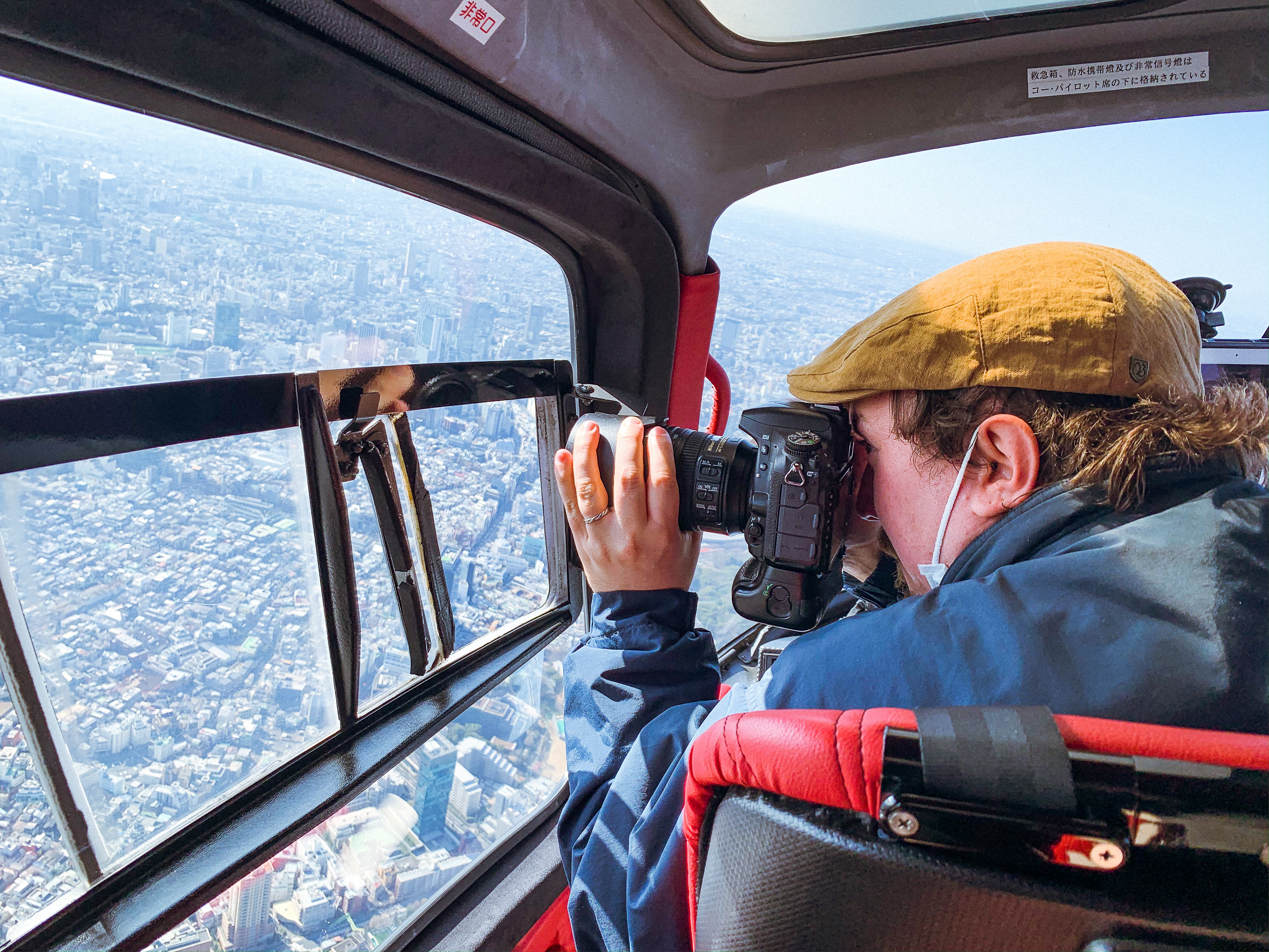 Sebastian Angel photographing tokyo from a chopper. 