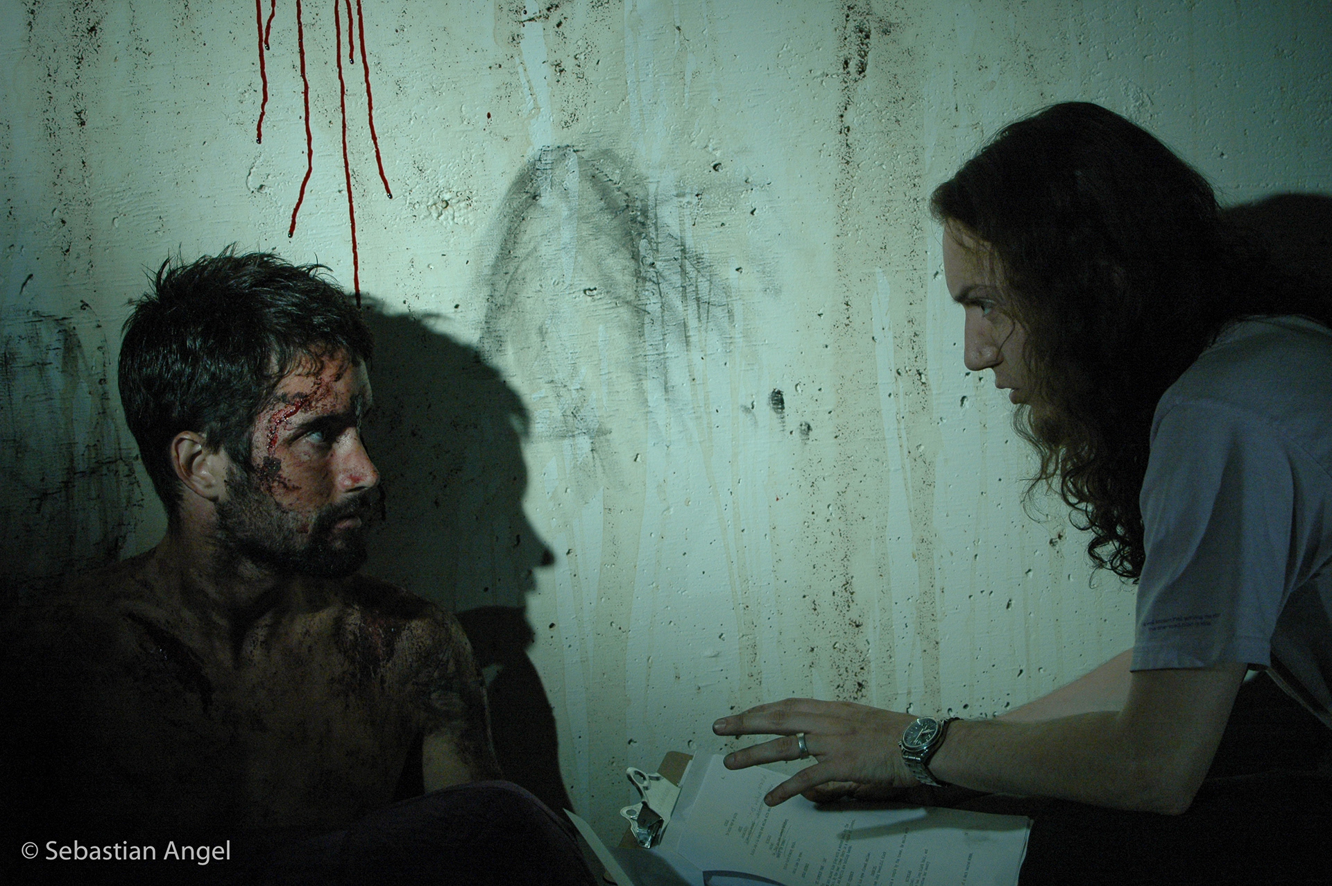 Director Sebastian Angel and actor Casey Manderson discussing the scene.