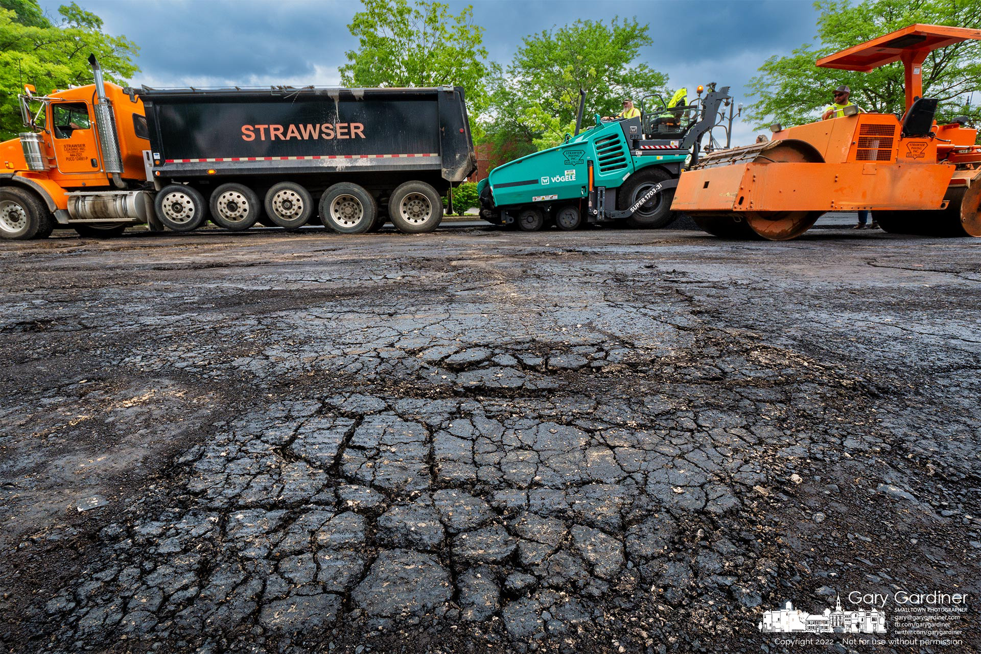 A paving crew applies the first coat of fresh asphalt after milling away the old surface for the Home And State Streets parking lot. My Final Photo for June 9, 2022.