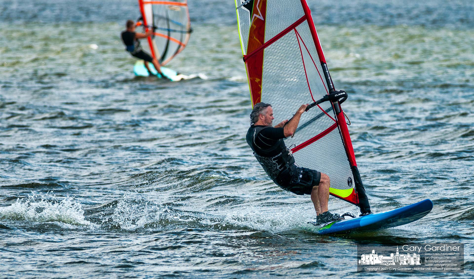 Sailboarders enjoy 30-mile-an-hour winds gusts to propel themselves across the choppy waters of Hoover Reservoir. My Final Photo for Sept. 1, 2021.