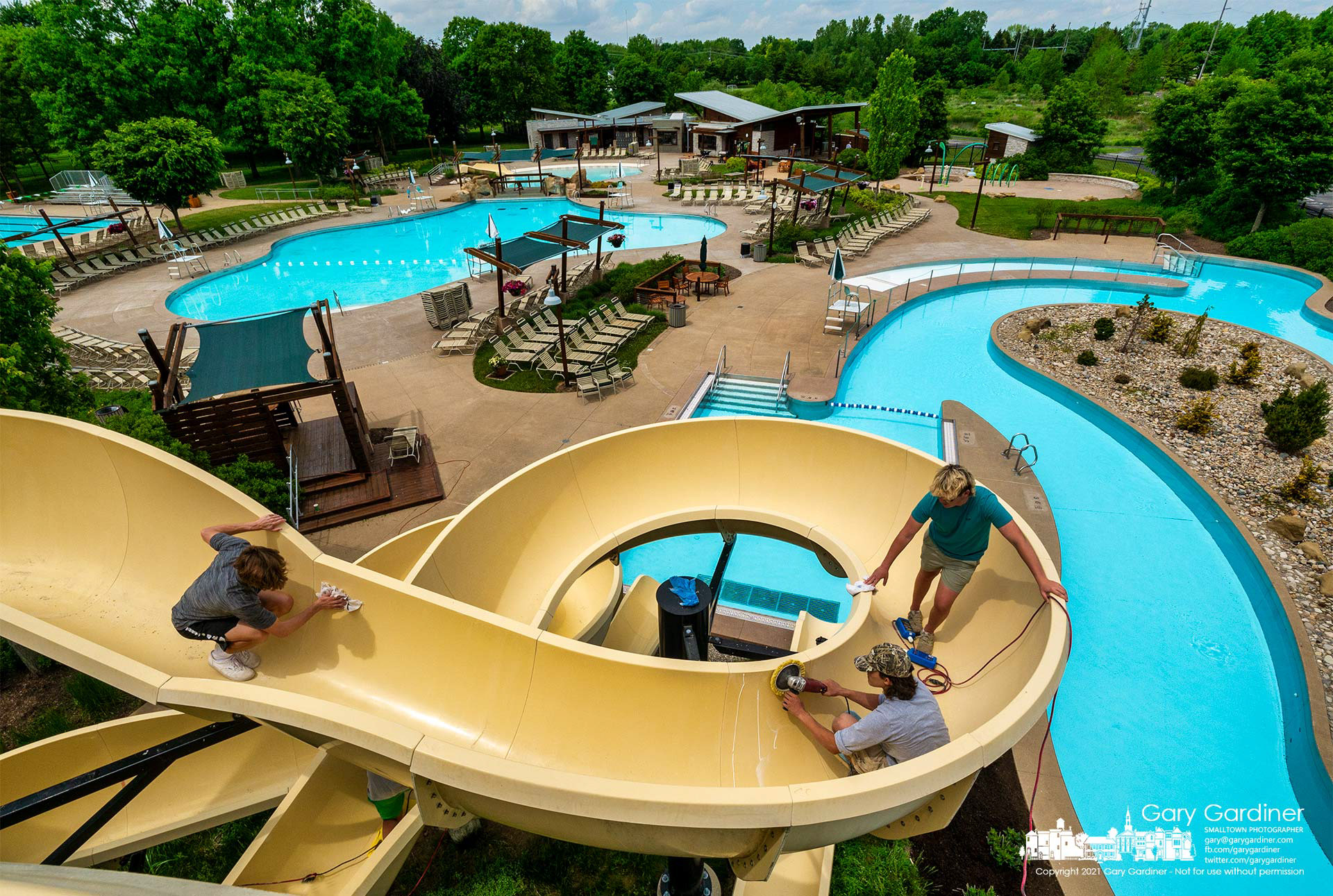 The main slide at Highlands Aquatic Center gets polished and a fresh coat of wax as the city parks department prepares to open the pool Saturday after missing last year due to the pandemic. My Final Photo for May 27, 2021.