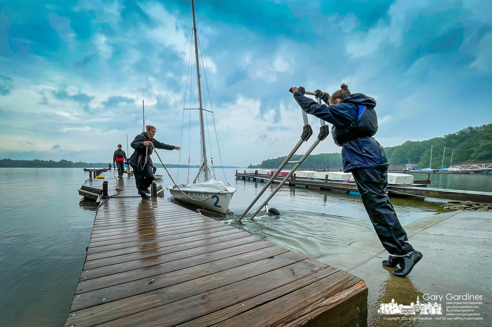 A sailor helps her boatmate load their sailboat onto its trailer after sailing Hoover Reservoir as a portion of their certification process. My Final Photo for June 3, 2021.