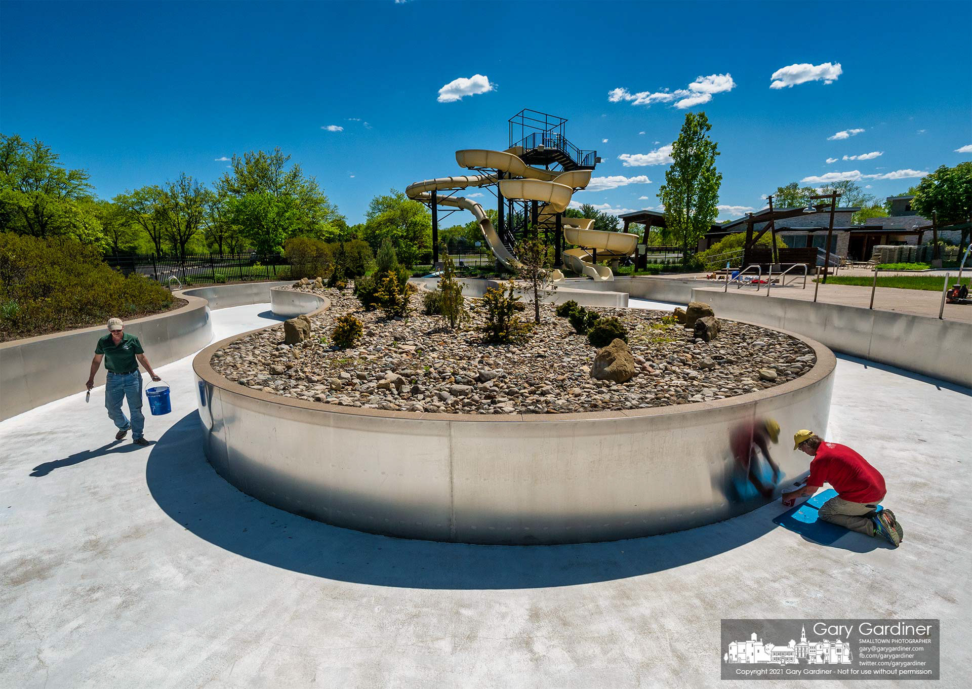 Westerville Park and Recreation workers paint the edges of the lazy river pool bottom at Highlands Aquatic Center as the city prepares to open the entire pool on Memorial Day weekend. My Final Photo for May 13, 2021.
