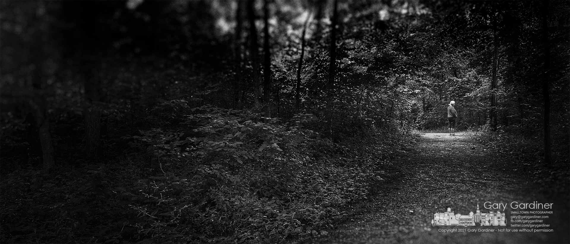 A woman pauses during a walk at Boyer Nature Preserve to wait for her companion to join her along the entrance path. My Final Photo for July 13, 2021. 