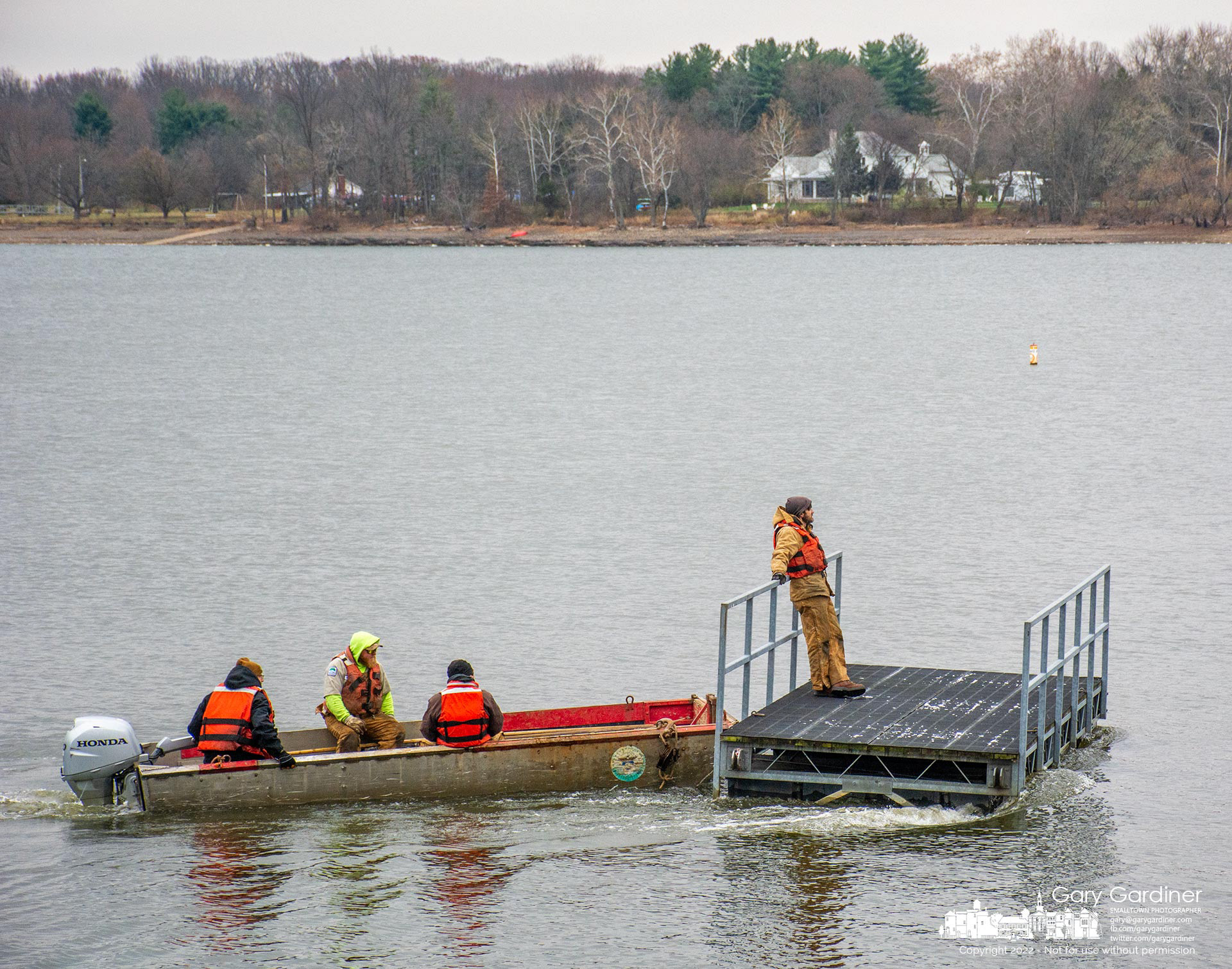 A City of Columbus crew appears to be casually maneuvering a section of a boat dock across the near-calm waters of Hoover Reservoir as if on a gentle afternoon pleasure cruise as they move the dock section to shore for winter storage. My Final Photo for November 17, 2022.