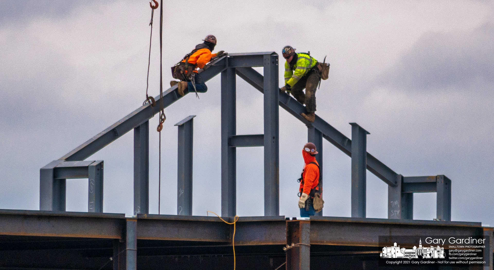 A pair of steelworkers attach struts to beams at the top of the new health care facility under construction at the corner of County Line and Africa Roads. My Final Photo for Jan. 27, 2021.