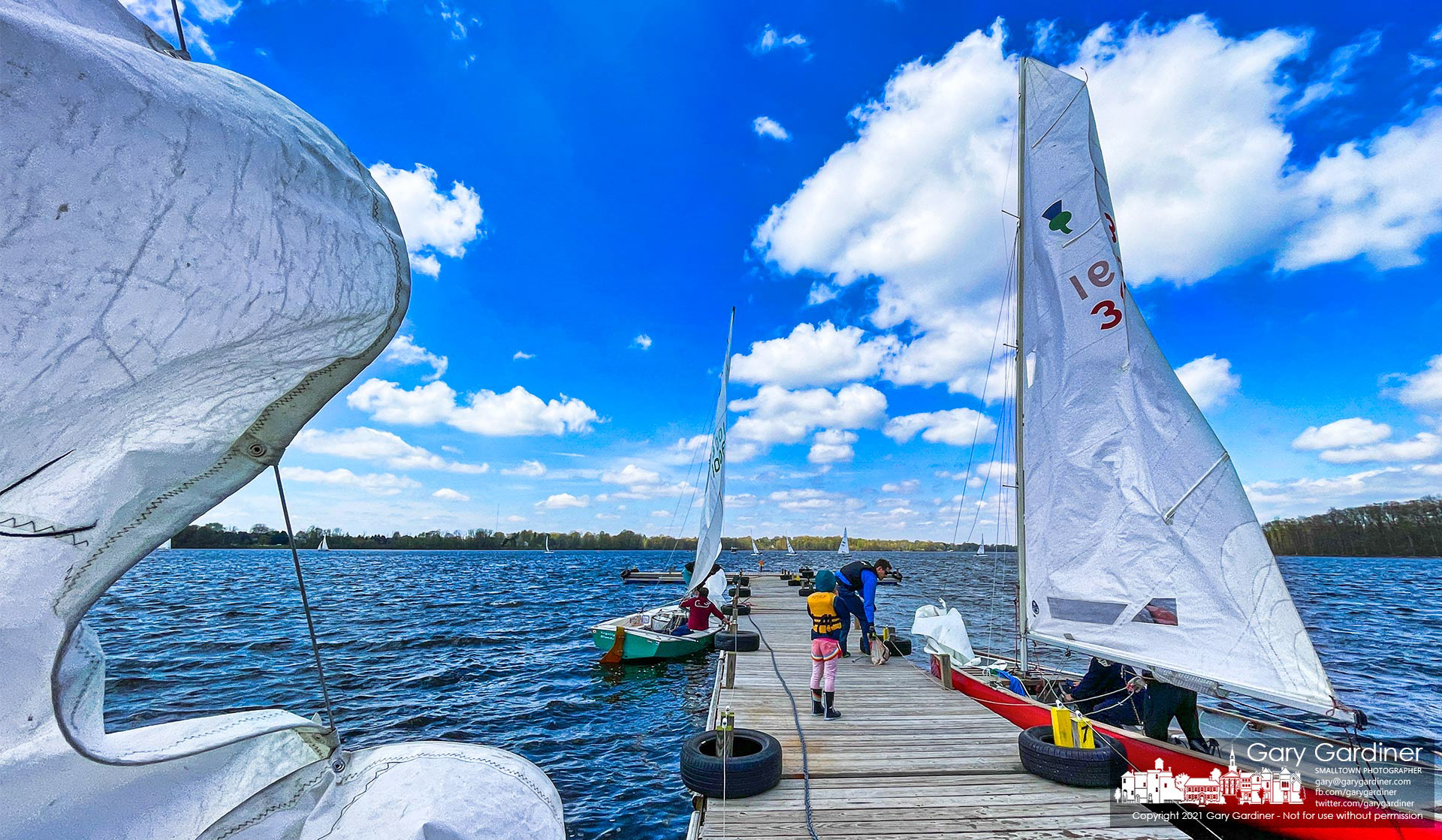 Sailors return to and prepare for launch from the docks at Hoover Sailing Club on a day that brought 30-mph gusts and temperatures in the mid-50s making for brisk sailing. My Final Photo for April 25, 2021.