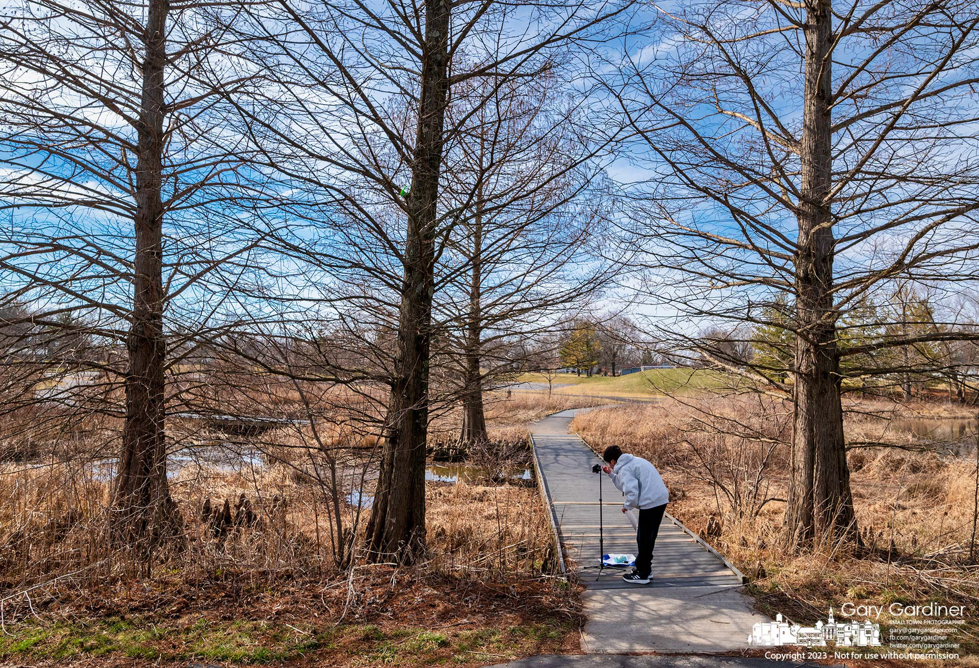 A student adjusts his phone camera before recording another segment of a school video project at the wetlands at Highlands Park in Westerville. My Final Photo for February 18, 2023. 