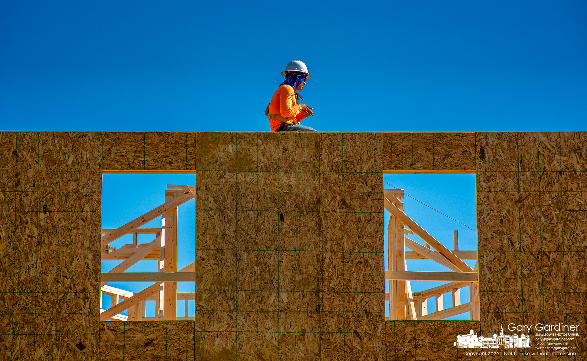 A carpenter waits for more materials to be delivered to his spot on the third floor of an office and apartment building being built on South State Street next to the post office. My Final Photo for October 11, 2022.