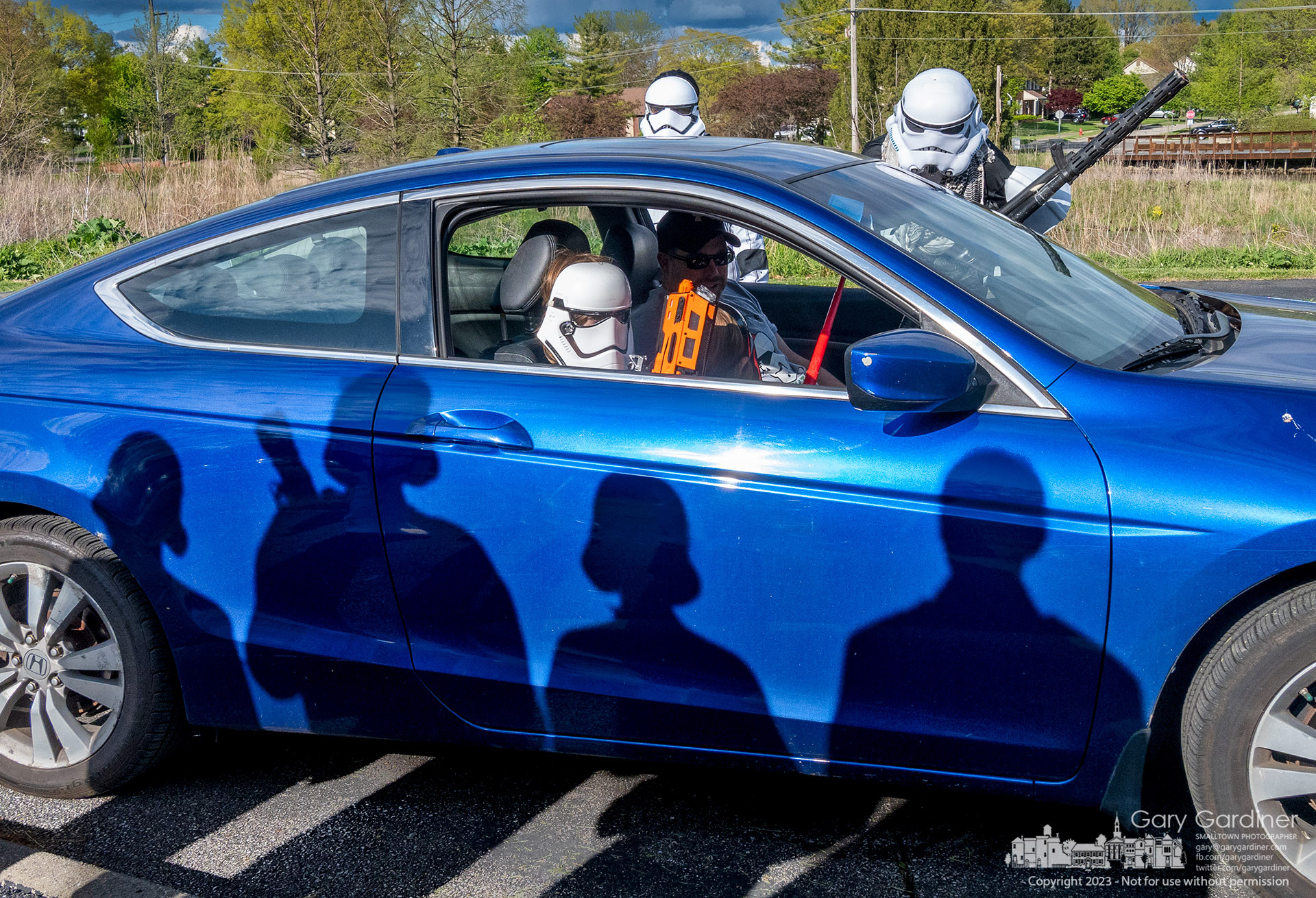 Shadows from a phalanx of Imperial Guard fall on a vehicle being investigated by Stormtroopers at Highlands Pool before dropping off food items for W.A.R.M. on Star Wars Day, May 4. My Final Photo for May 4, 2023. Photo Copyright 2023 Gary Gardiner. Not to be used without written permission detailing exact usage. Photos from Gary Gardiner, may not be redistributed, resold, or displayed by any publication or person without written permission. Photo is copyright Gary Gardiner who owns all usage rights to the image.