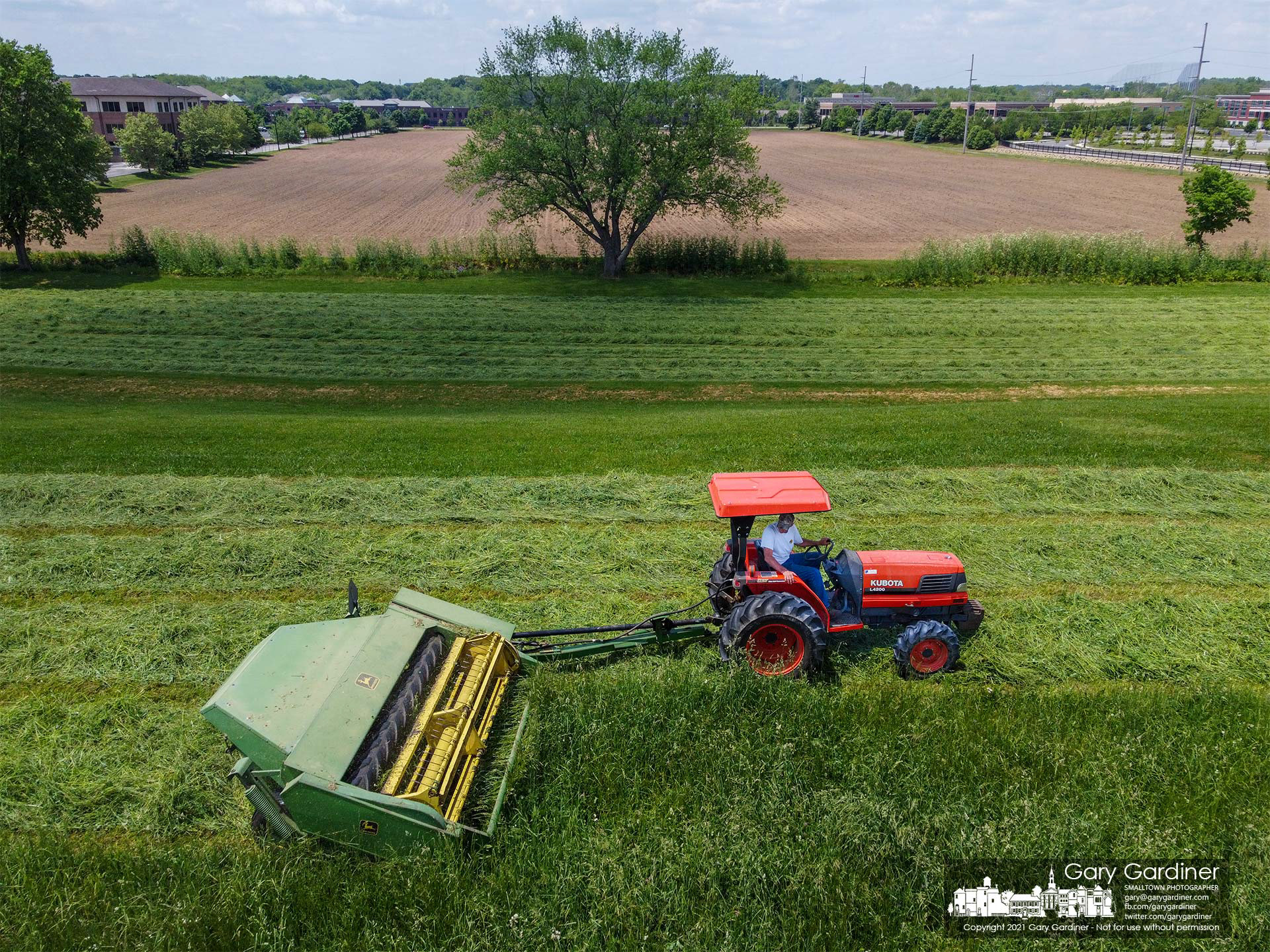 Duane Yarnell mows hay behind his barns and just above the large field recently planted with soybeans. My Final Photo for May 23, 3021.