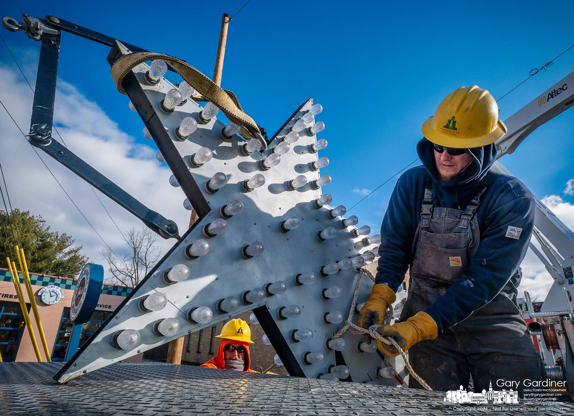 A city worker ties down the Christmas Star after it was removed from over State Street at Home where it was raised after the move from State and Main. My Final Photo for Jan. 3, 2022.