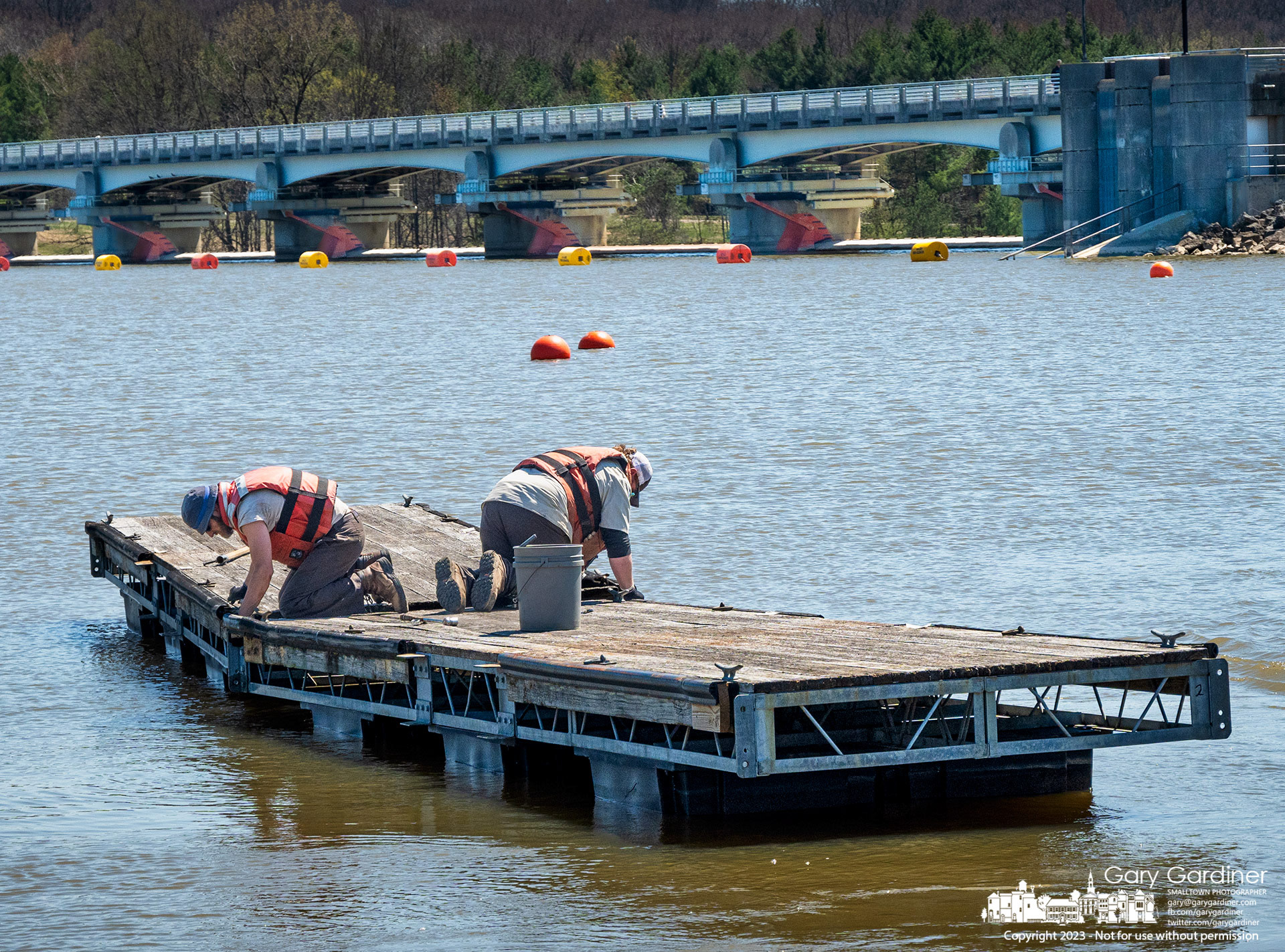Columbus Parks workers connect two sections of docks before moving them into position to create a small boat harbor just north of the Hoover Reservoir Dam marking one of the signs of Spring. My Final Photo for April 12, 2023. https://bit.ly/3GEapN9
