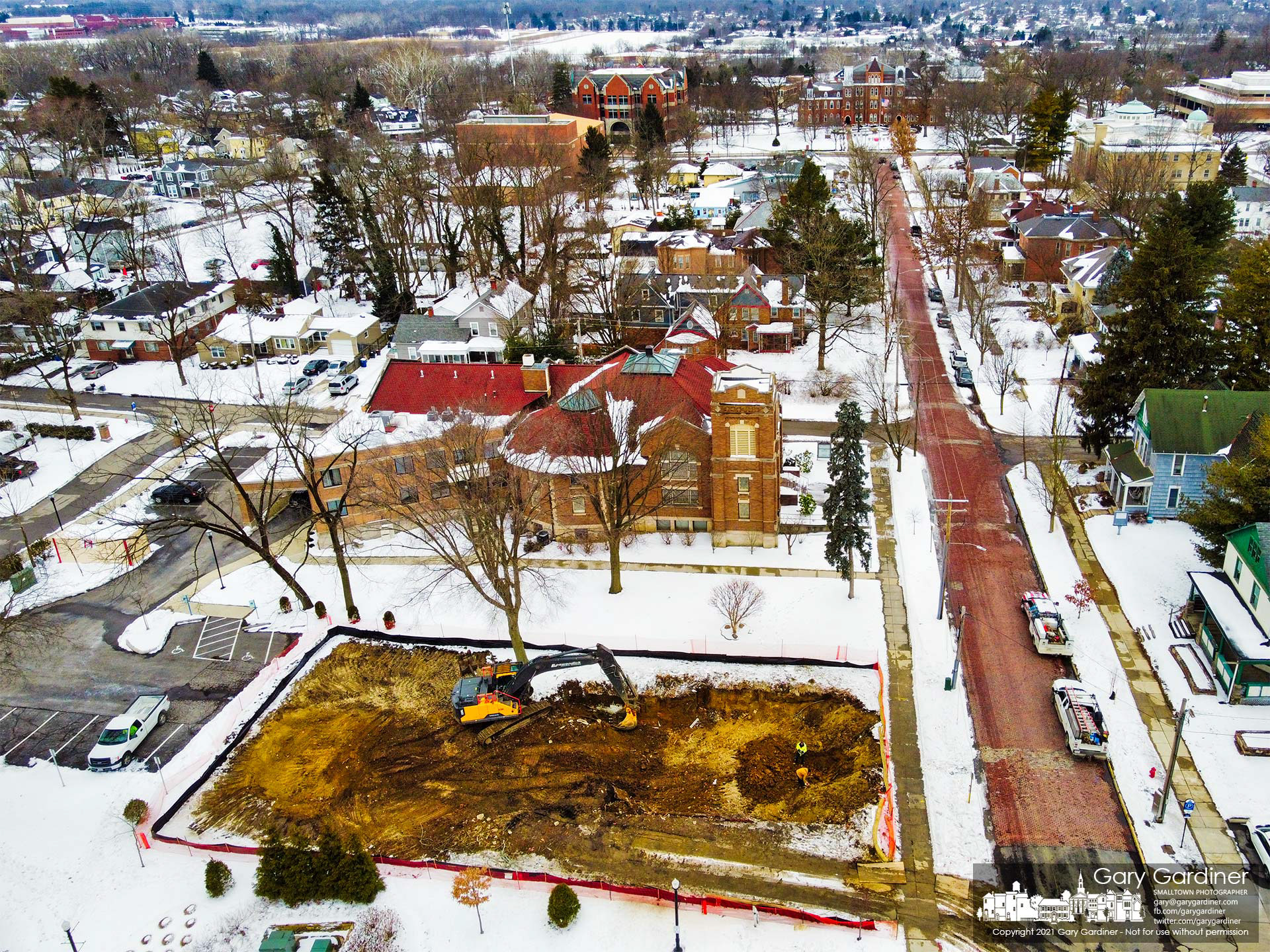 A demolition crew clears the ground after demolishing a house behind city hall to make way for a parking lot expansion. My Final Photo for Feb. 5, 2021. 