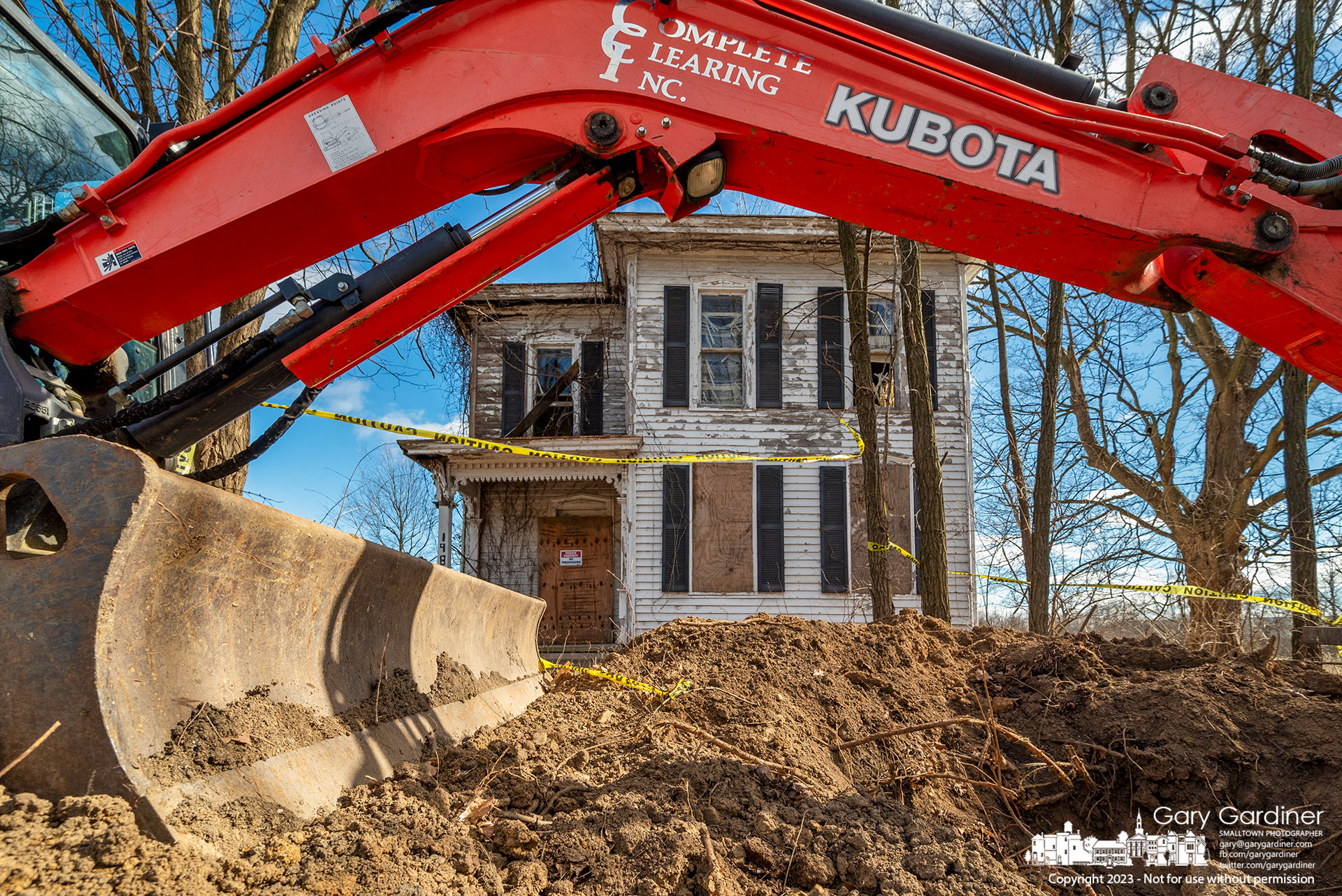 A work crew checks to make sure all underground utilities are disconnected from the Braun Farm barn and home as it prepares to demolish the two buildings. My Final Photo for February 3, 2023. 