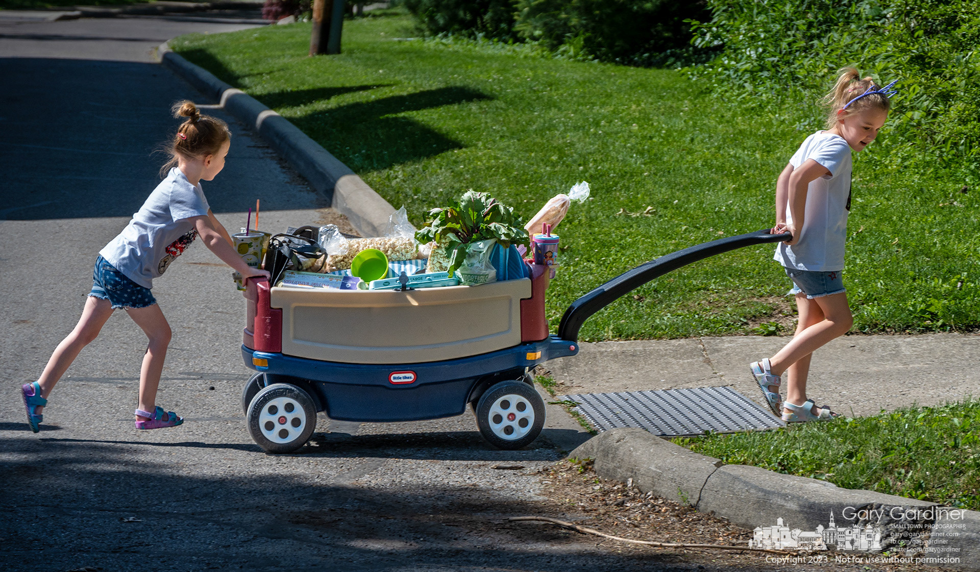 Sisters push and pull their fully-loaded wagon home after spending part of Saturday morning shopping at the Uptown Westerville Farmers Market.  My Final Photo for May  27, 2023. 