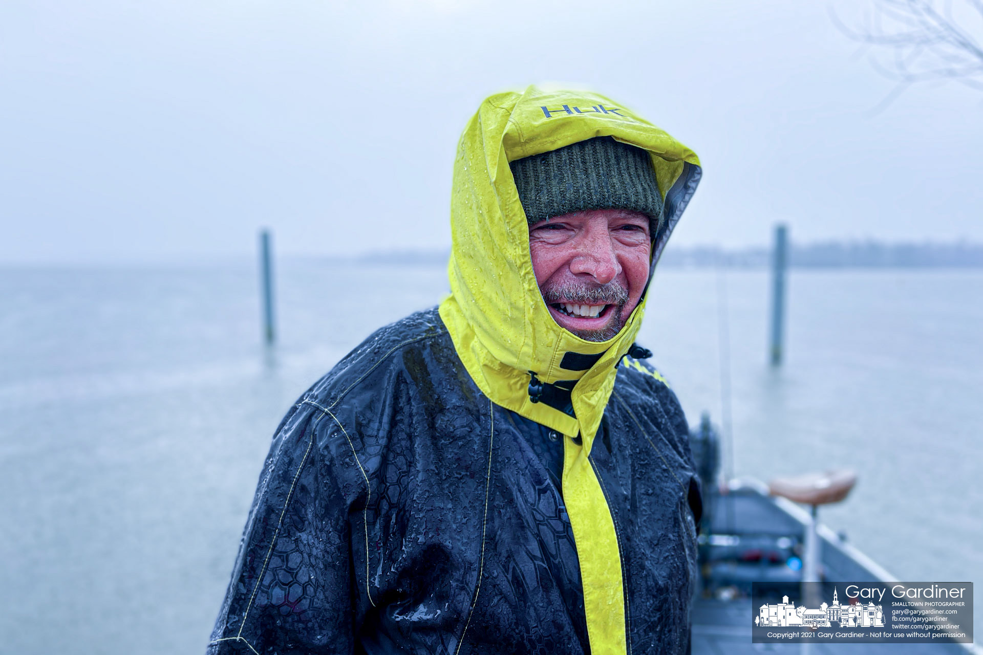 A fisherman smiles after tieing his boat off at the Red Bank boat ramp as he escapes a heavy rain that greeted him after a morning with little success on Hoover Reservoir. My Final Photo for March 11, 2021.