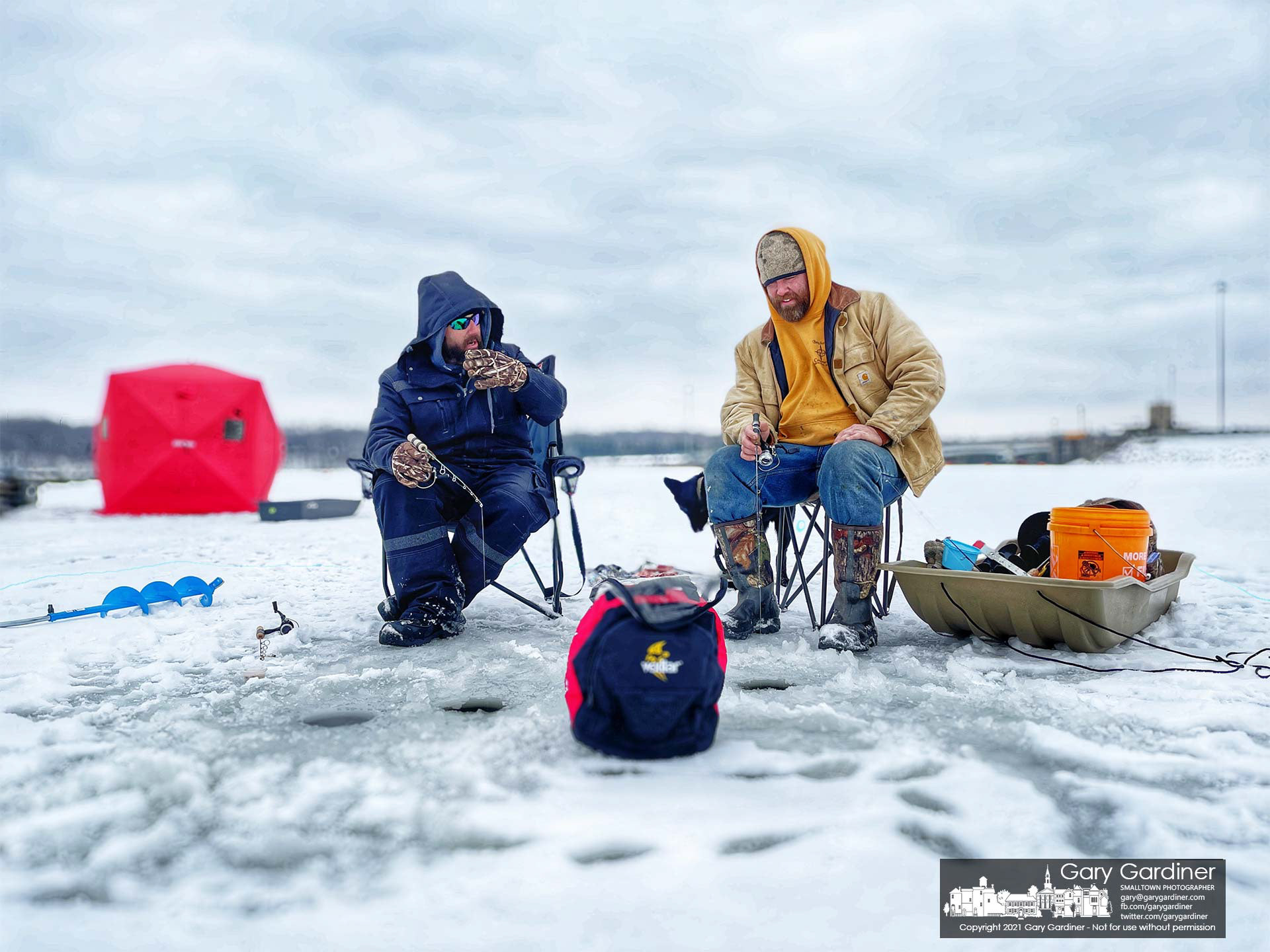 A pair of anglers fish on about five inches of ice where boat docks float in the summer on Hoover Reservoir near the dam. My Final Photo for Feb. 12, 2021.