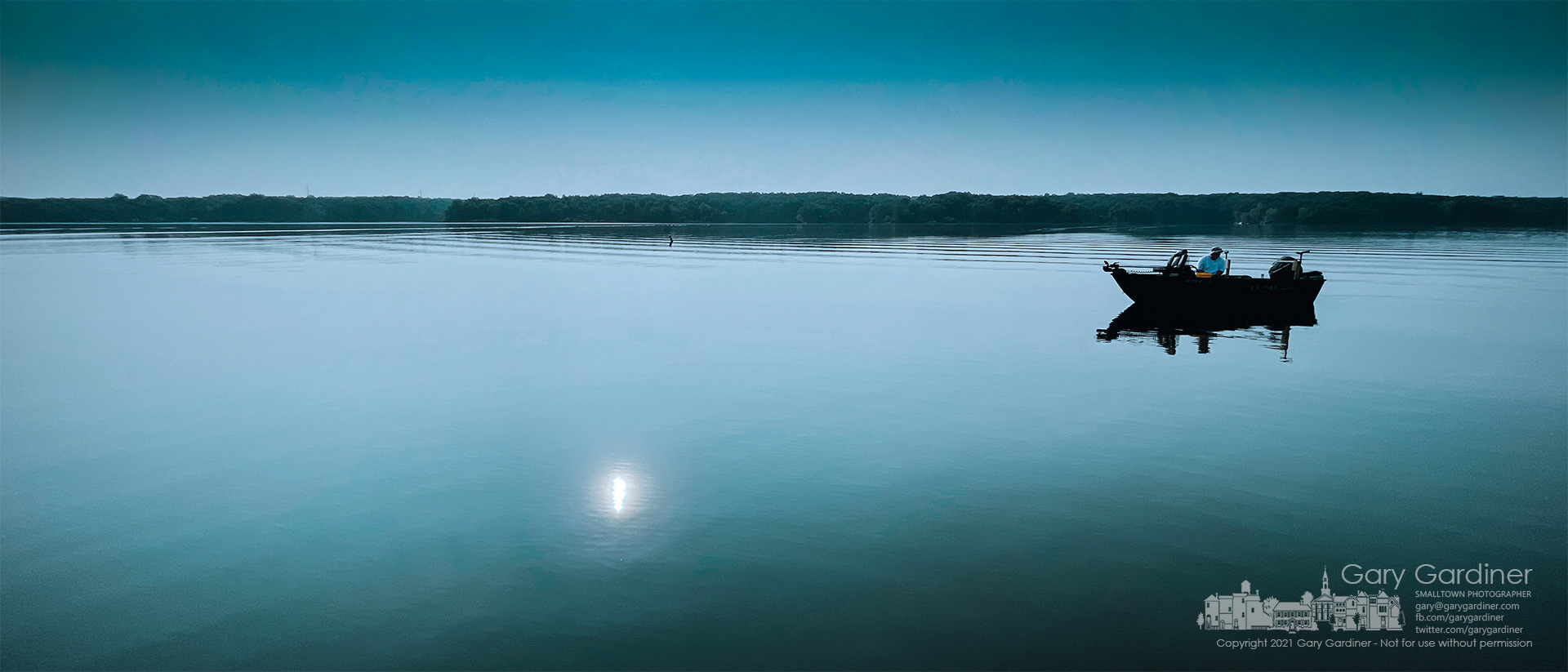 A fisherman sits idle on the Hoover Reservoir, its still waters disturbed only by his return to the docks after an early morning fishing. My Final Photo for July 28, 2021. 