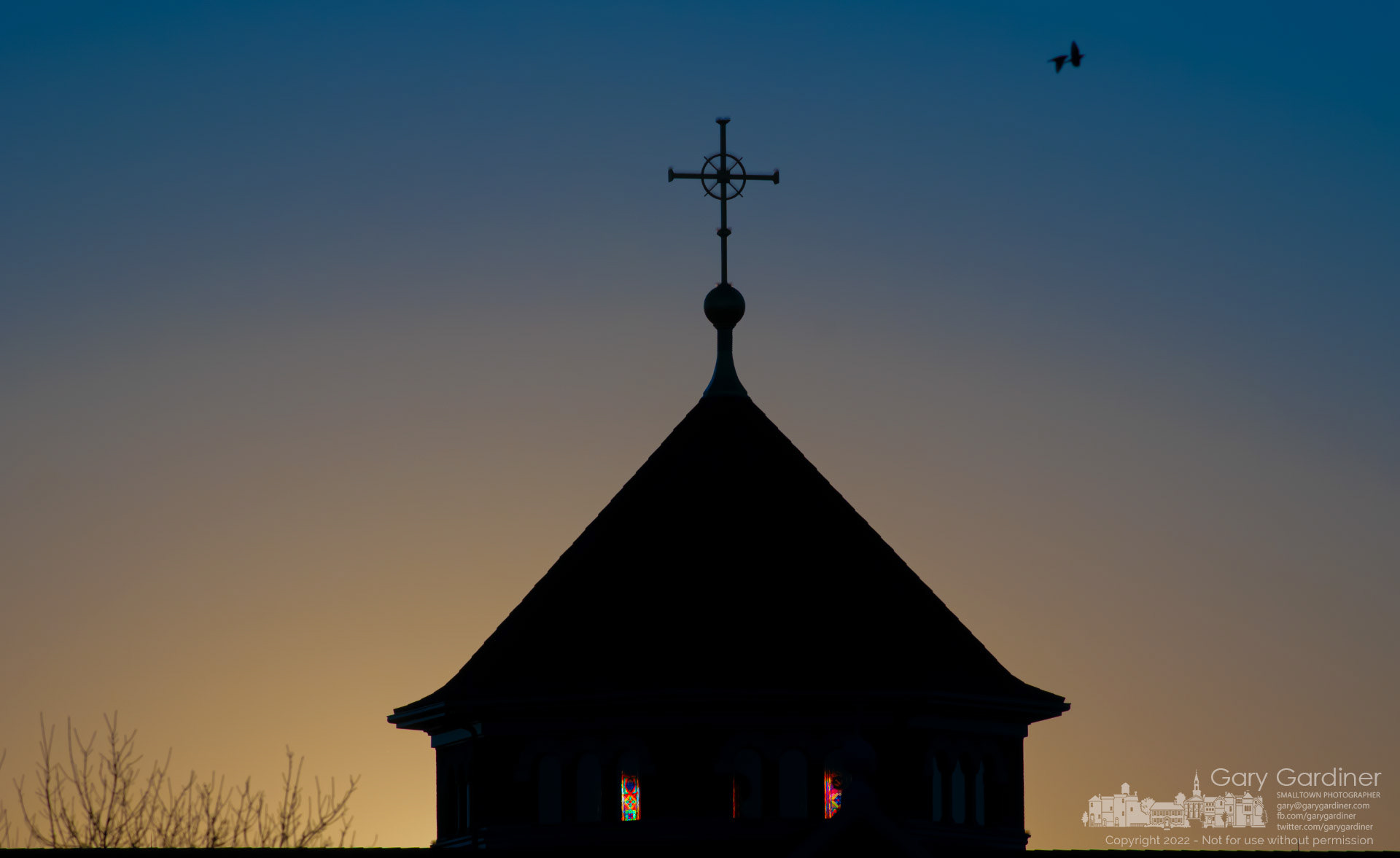 The morning sun rises behind the St. Paul the Apostle Catholic Church steeple illuminating a few of the stained glass windows. My Final Photo for Feb. 20, 2022.