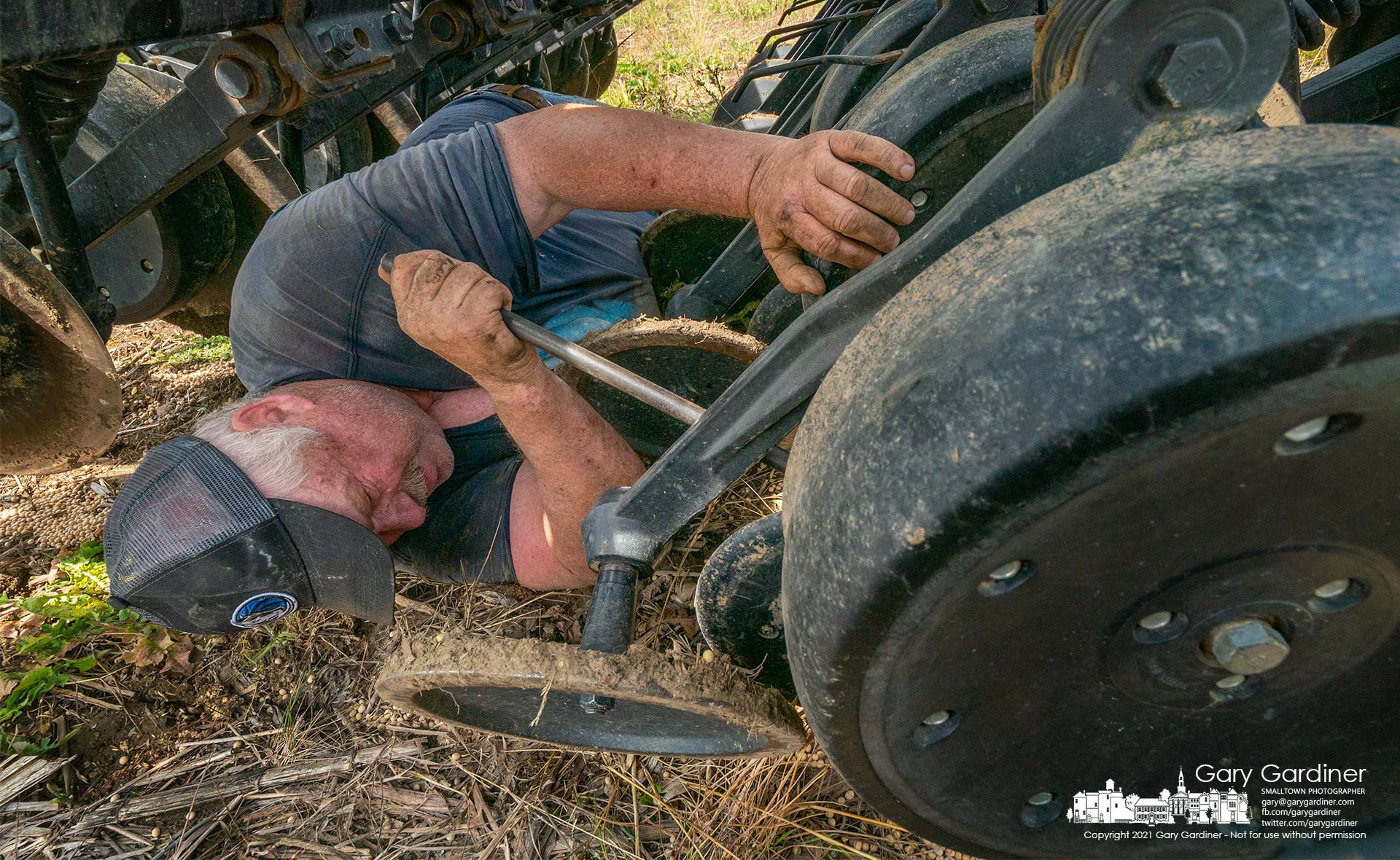 Farmer Kevin Scott adjusts springs on the no-till seed drill before beginning the second planting of portions of the Braun Farm fields. My Final Photo for June 8, 2021.