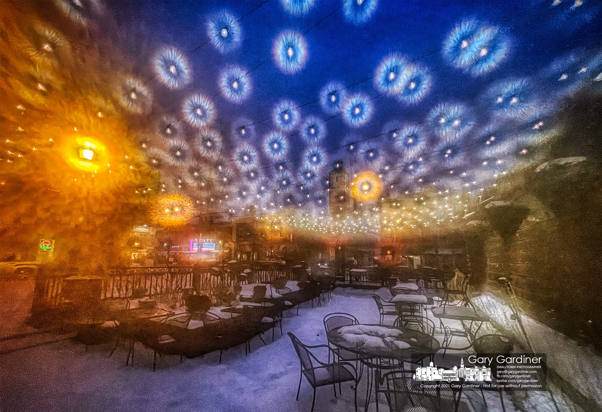 The patio lights at Jimmy V's glisten during a sleet storm that preceded the forecast for heavy overnight snow in Central Ohio. M