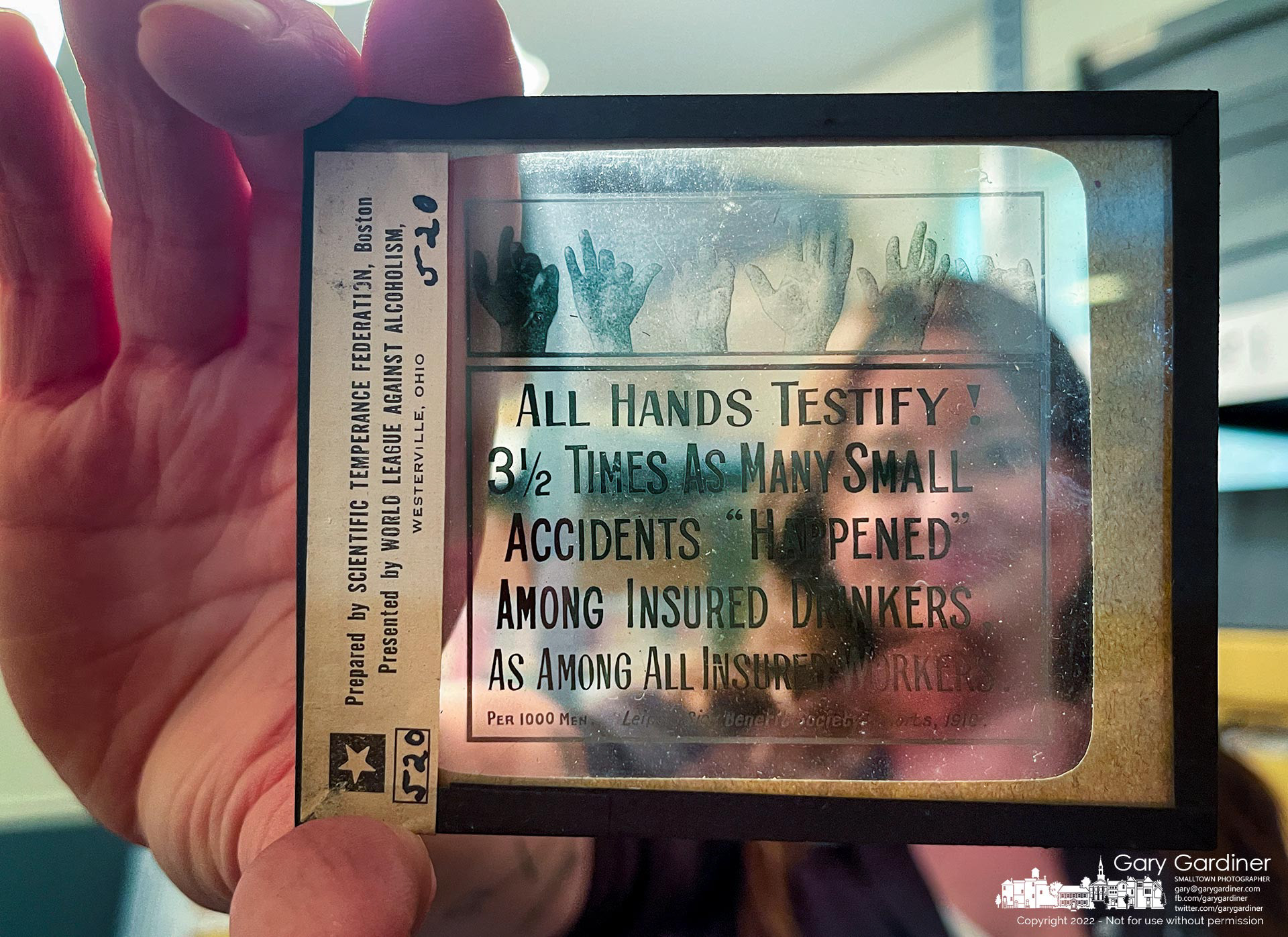 Westerville History Museum Manager Nina Thomas holds one of the museum's prohibition-era lantern slides returned to the library from storage at the Ohio History Collection where it and other items in the museum were temporarily stored. My Final Photo for June 13, 2022.