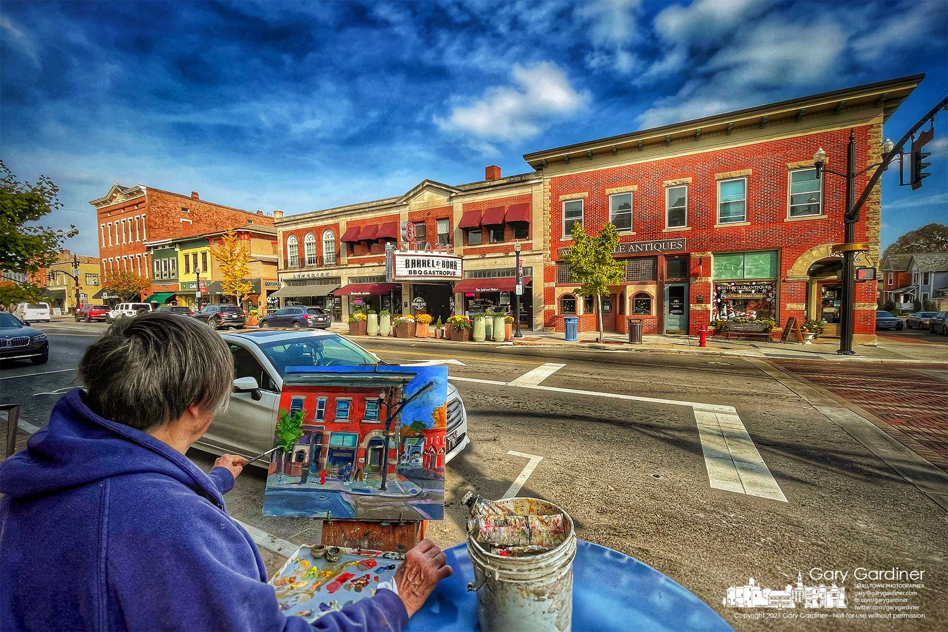 An artist works at completing her version of the northeast corner of State and College in Uptown Westerville hoping to add depth and tone to the project she began the day before. My Final Photo for Nov. 10, 2021.