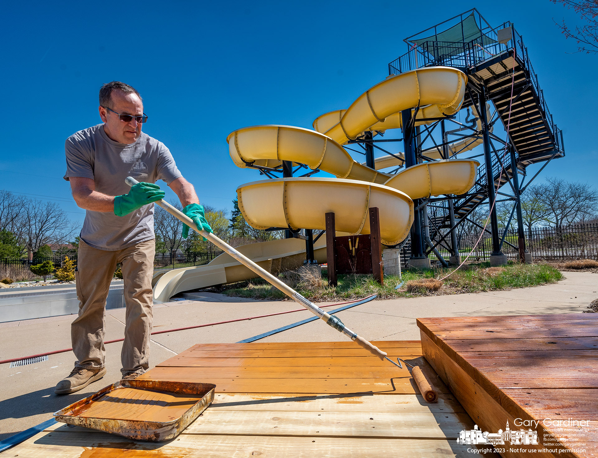 The recently repaired decking at a Highlands Aquatic Park pavilion gets a coat of finishing stain as the city parks department prepares the pools, decks, and picnic tables for opening May 27, 2023. My Final Photo for April 11, 2023. 
