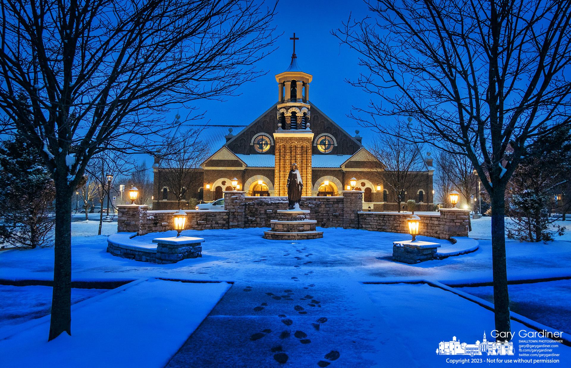 Steps in the morning snow lead to the Mary statue at St. Paul the Apostle Catholic Church before the first Sunday Mass. My Final Photo for March 12, 2023.  