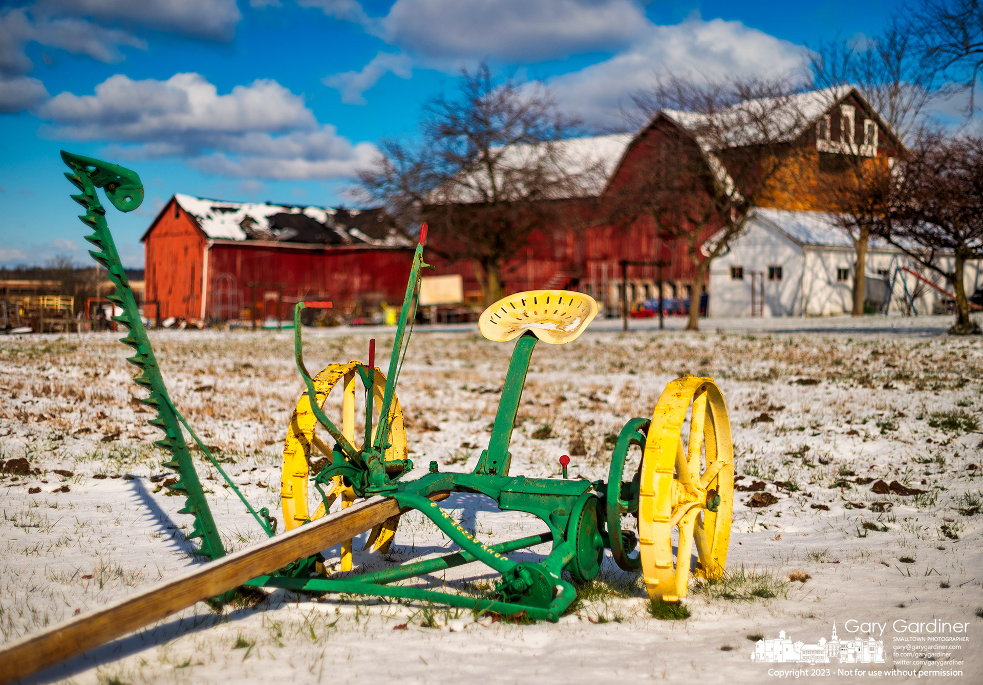The morning sun casts a bright sharp light over an antique sickle mower sitting at the edge of a snowy garden and field at the Yarnell Farm on Africa Road. My Final Photo for March 14, 2023. - https://bit.ly/3yAn9jr