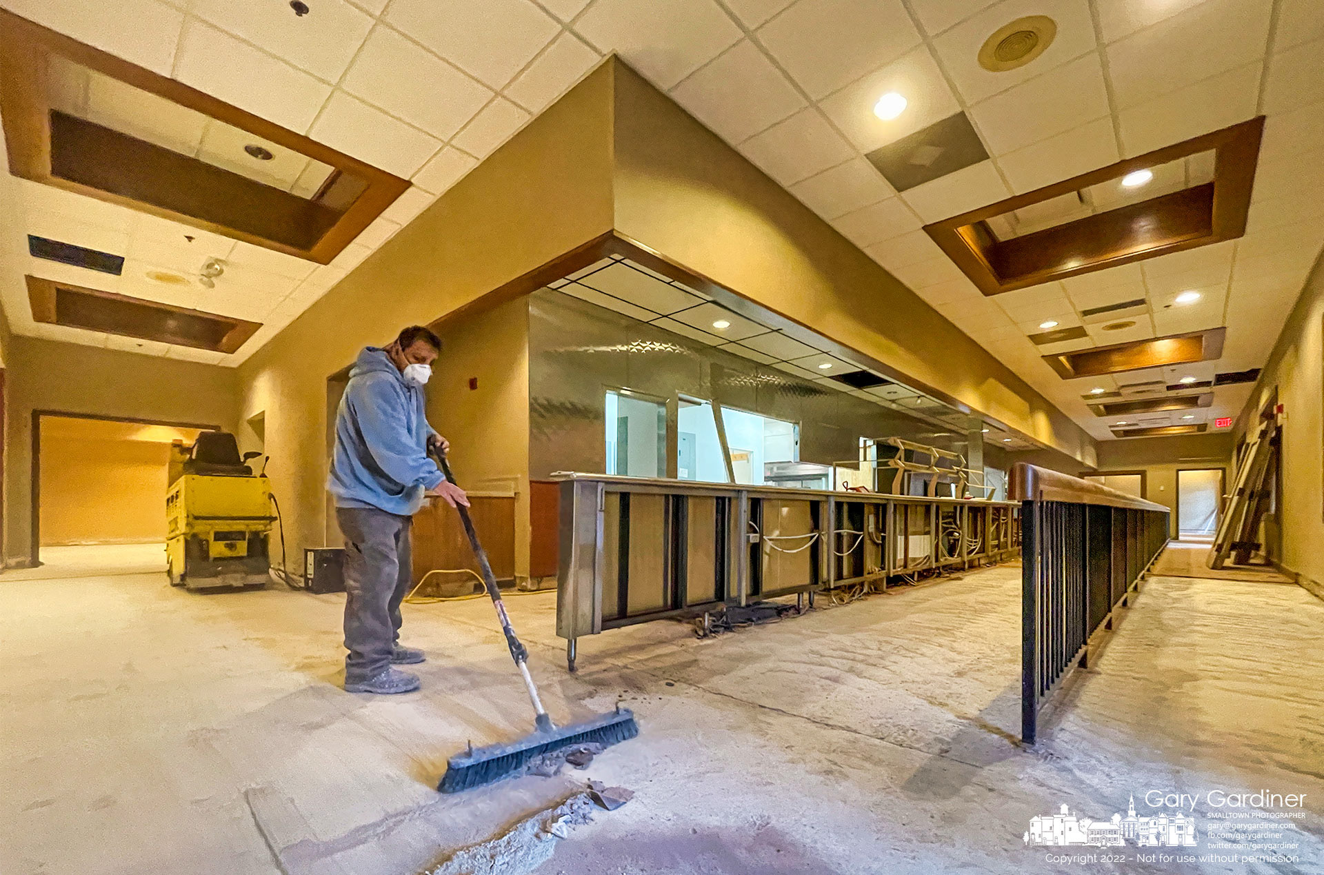 A work crew clears dust and debris during the removal of restaurant equipment and tile flooring from a portion of the closed MCL Restaurant where the large space will be converted into three storefronts. My Final Photo for Feb. 2, 2022.