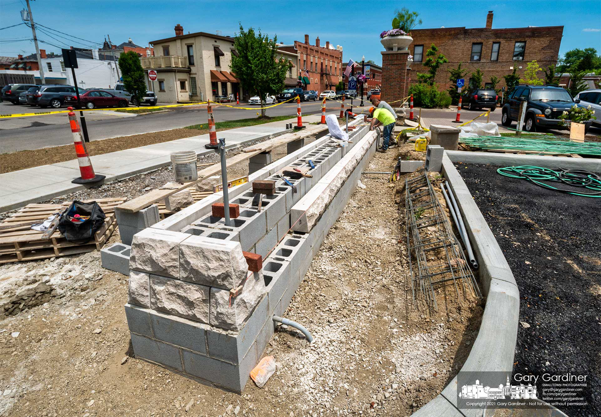 Masons install decorative sections of concrete that are the base for the new pillars and planters that will sit at the entrance of the new parking lot behind city hall. My Final Photo for June 24, 2021. 
