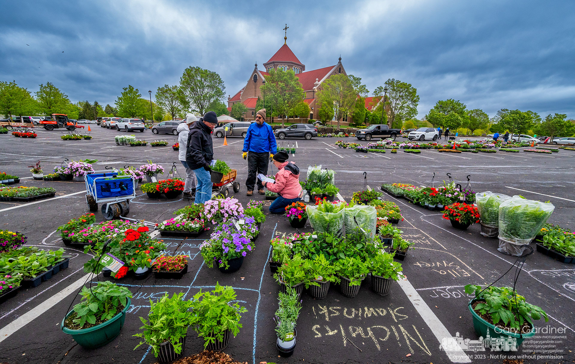 Volunteers prepare to load flowers and plants sorted by family name into vehicles picking up items from the annual plant sale at St. Paul the Apostle School in Westerville. My Final Photo for May 3, 2023. 