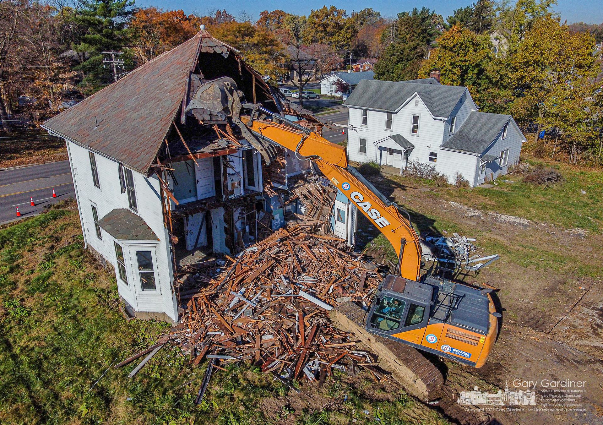 A work crew tears away the rear of the larger of two abandoned houses demolished Monday on South State Street to make way for a new structure housing business and apartments. My Final Photo for Nov. 8, 2021.