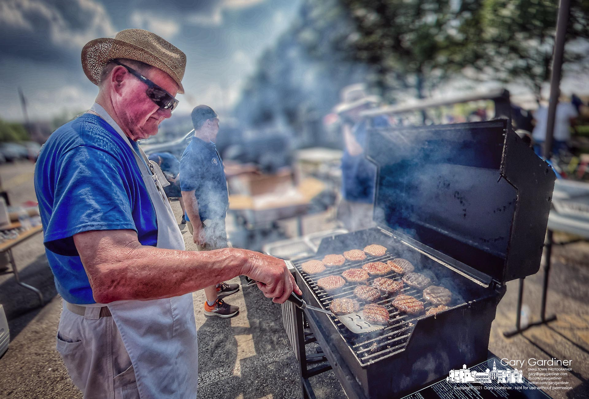 Smoke rolls from grills cooking hamburgers, hot dogs, and brats for the annual St. Paul family picnic. My Final Photo for Aug. 22, 2021. 