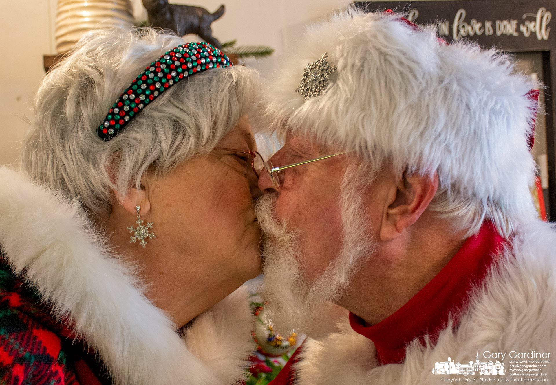 Santa and Mrs. Claus demonstrate that they don't need mistletoe to show affection for each other when they stopped at Westerville Florist during an afternoon stroll through Uptown Westerville where they encountered a number of young fans with gift lists, their parents with credit cards, and at least one Scrooge who didn't accept their offer of a candy cane. My Final Photo for December 10, 2022.