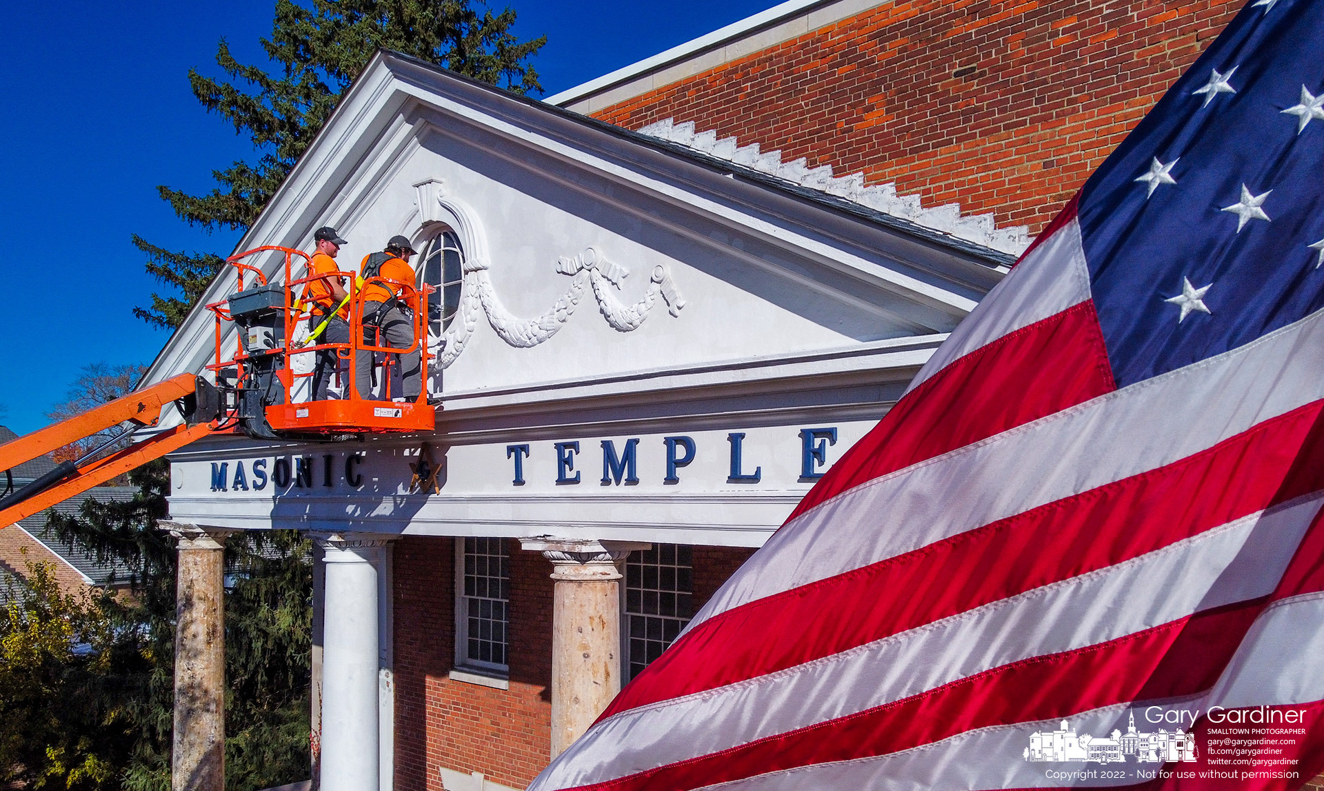 A work crew cleans the frame of the window at the top of the columned entrance to the Masonic Temple on South State Street as part of repairs of the building whose cornerstone was laid in 1930. My Final Photo for October 27, 2022.