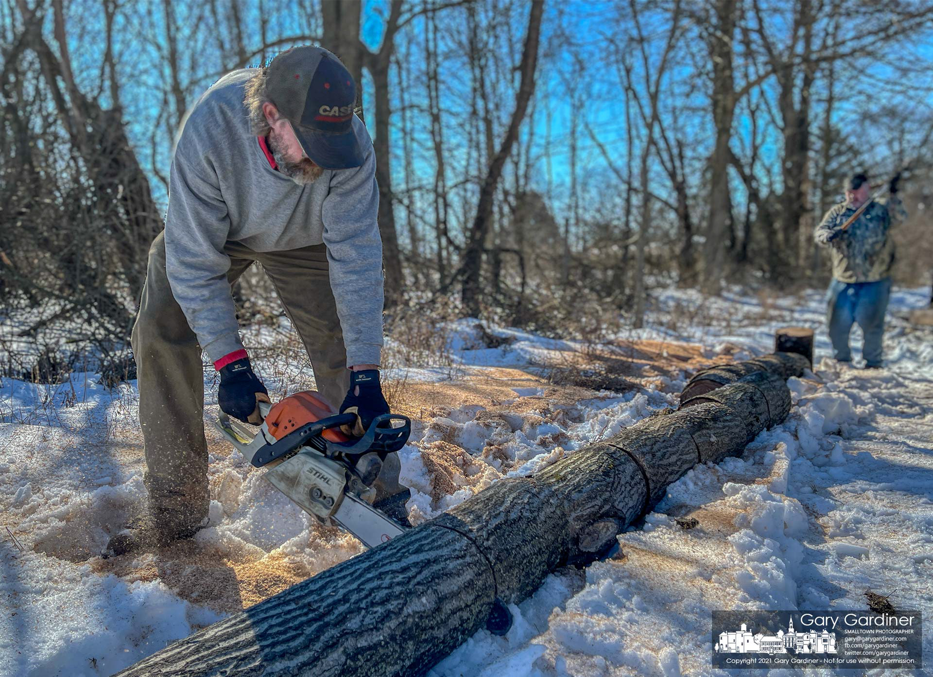 Rodney Parker and Kevin Scott cut and split firewood harvested from a field on Africa Road. My Final Photo for Feb. 23, 2021.