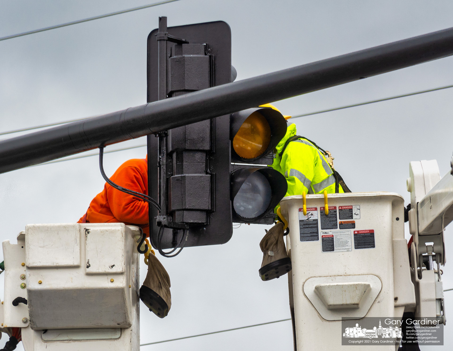 City electric workers complete rewiring a traffic signal that failed during Thursday's rainstorms causing the light to begin four-way flashing. My Final Photo for March 18, 2021.